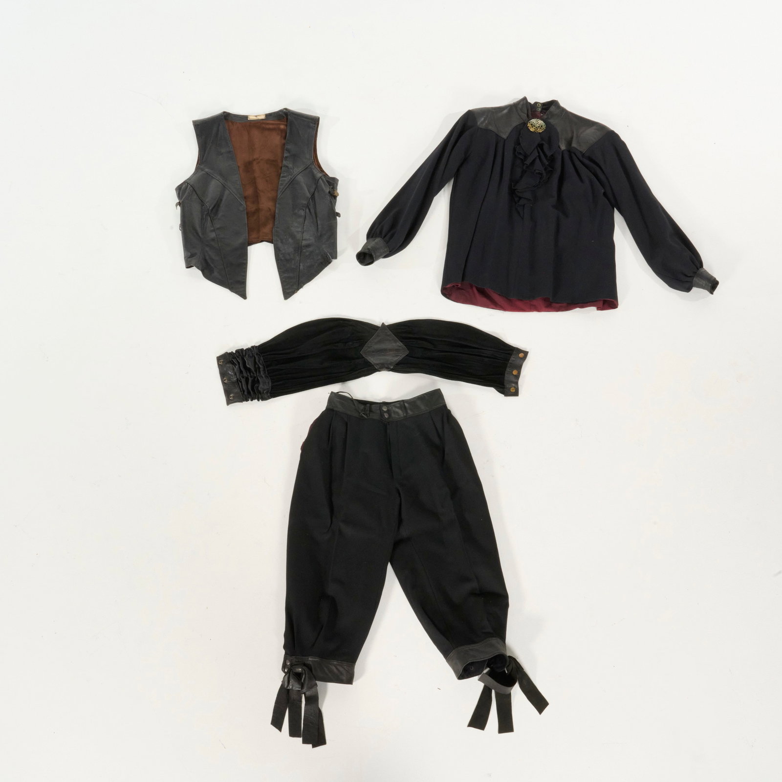 Original Royce Worn 18th Century Inspired Four-piece Costume (1989-1990): Original Royce worn 18th century inspired four-piece costume (1989-1990). The costume consists of a black leather vest, a long-sleeved blouse, a wide pleated cummerbund, and a pair of decorative breec