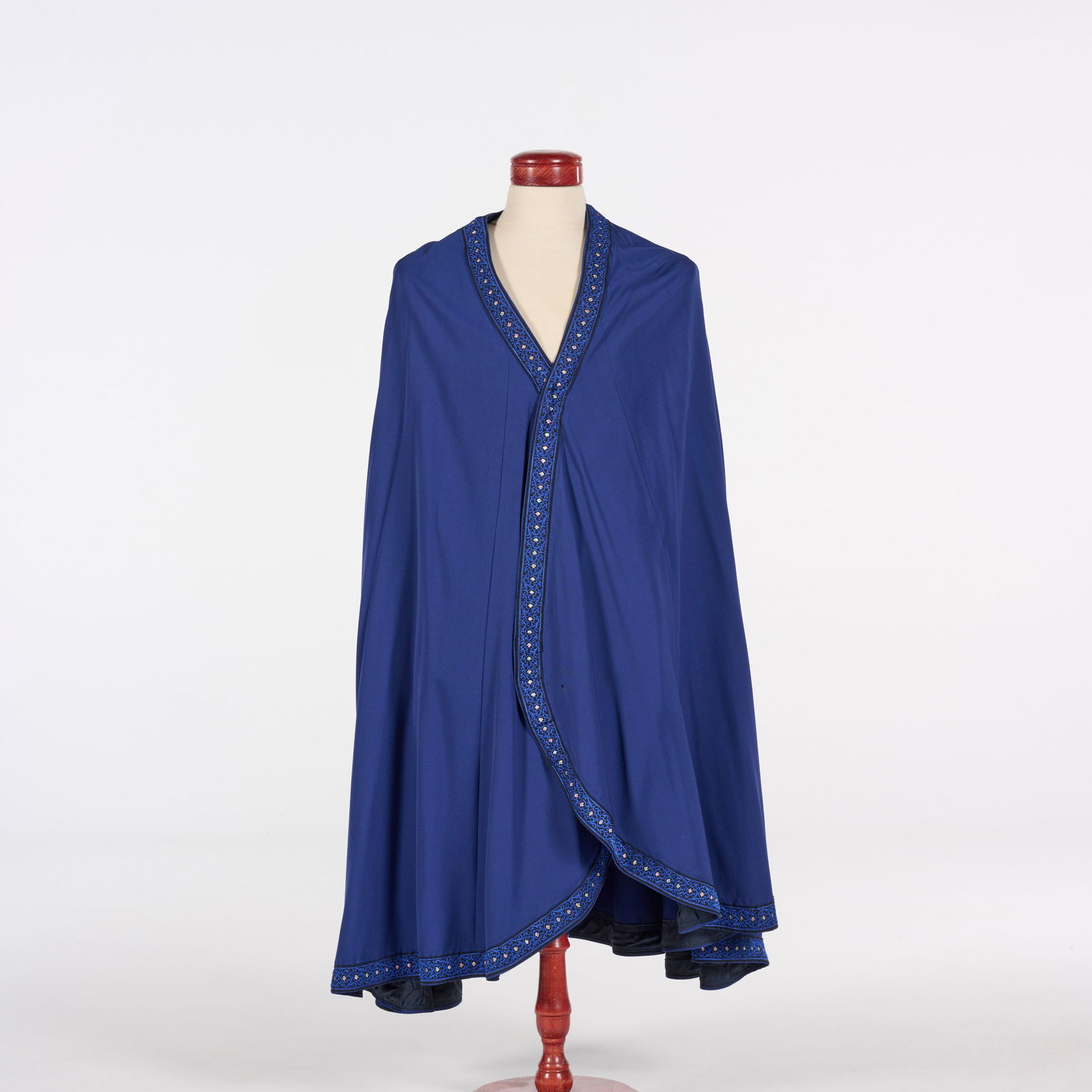 Original Royal Blue Cape with Ornate Trim from the Royce Collection: Original royal blue cape with ornate trim from the Royce Collection. Please use our provided images to judge the condition. Location: The Netherlands, Tilburg.