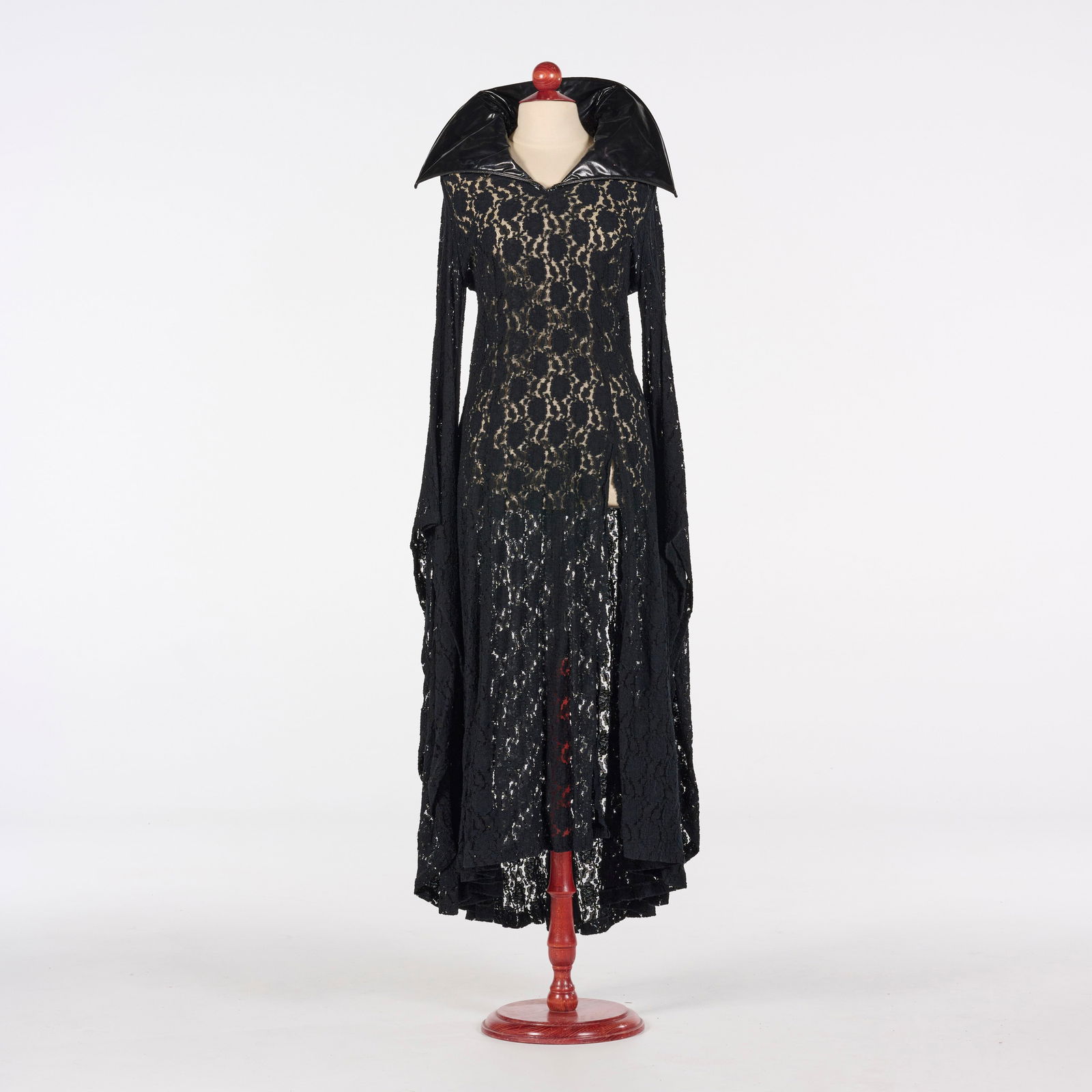 Original Black Floor-length Gothic "The Addams Family" Inspired Gown from the Royce Collection: Original black floor-length Gothic "The Addams Family" inspired gown from the Royce Collection. Crafted from intricate black floral lace, it features a dramatic, oversized, glossy stand-up collar, exc