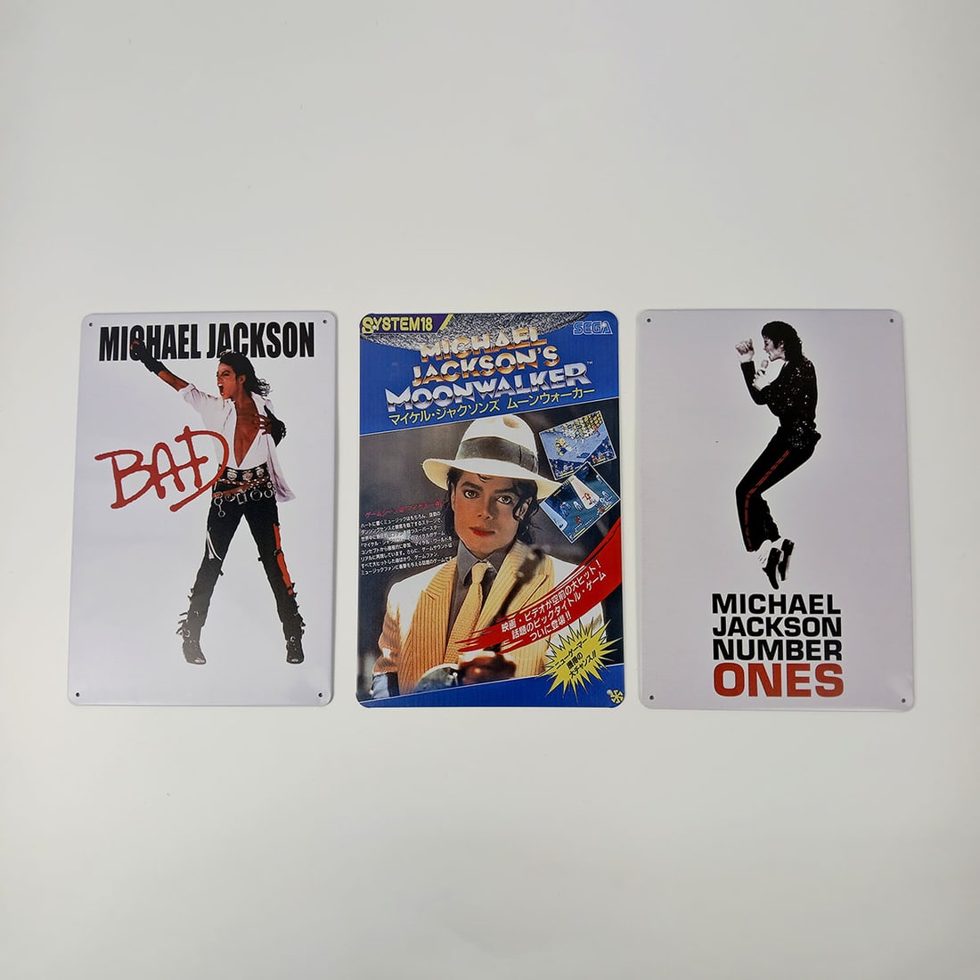 Lot of 3 Michael Jackson Collectible Metal Signs: Lot of 3 Michael Jackson collectible metal signs - "Bad", "Number Ones" and "Sega Michael Jackson's Moonwalker" in Japanese. Dimensions (H x W x D): 30 x 20 x 0.3 cm. Condition: Excellent. Location: