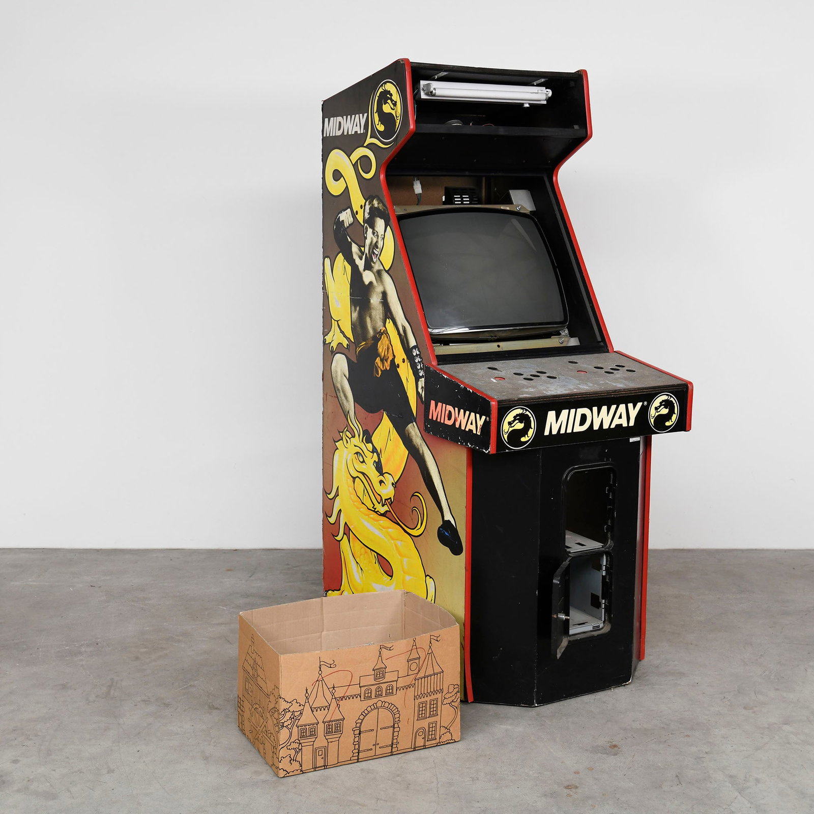 Mortal Kombat Arcade Cabinet by Midway and Parts (1992): Lot of parts of a Midway Mortal Kombat arcade cabinet, originally released in 1992. The upright cabinet features red trim and black main body with original side art depicting a fighting character and