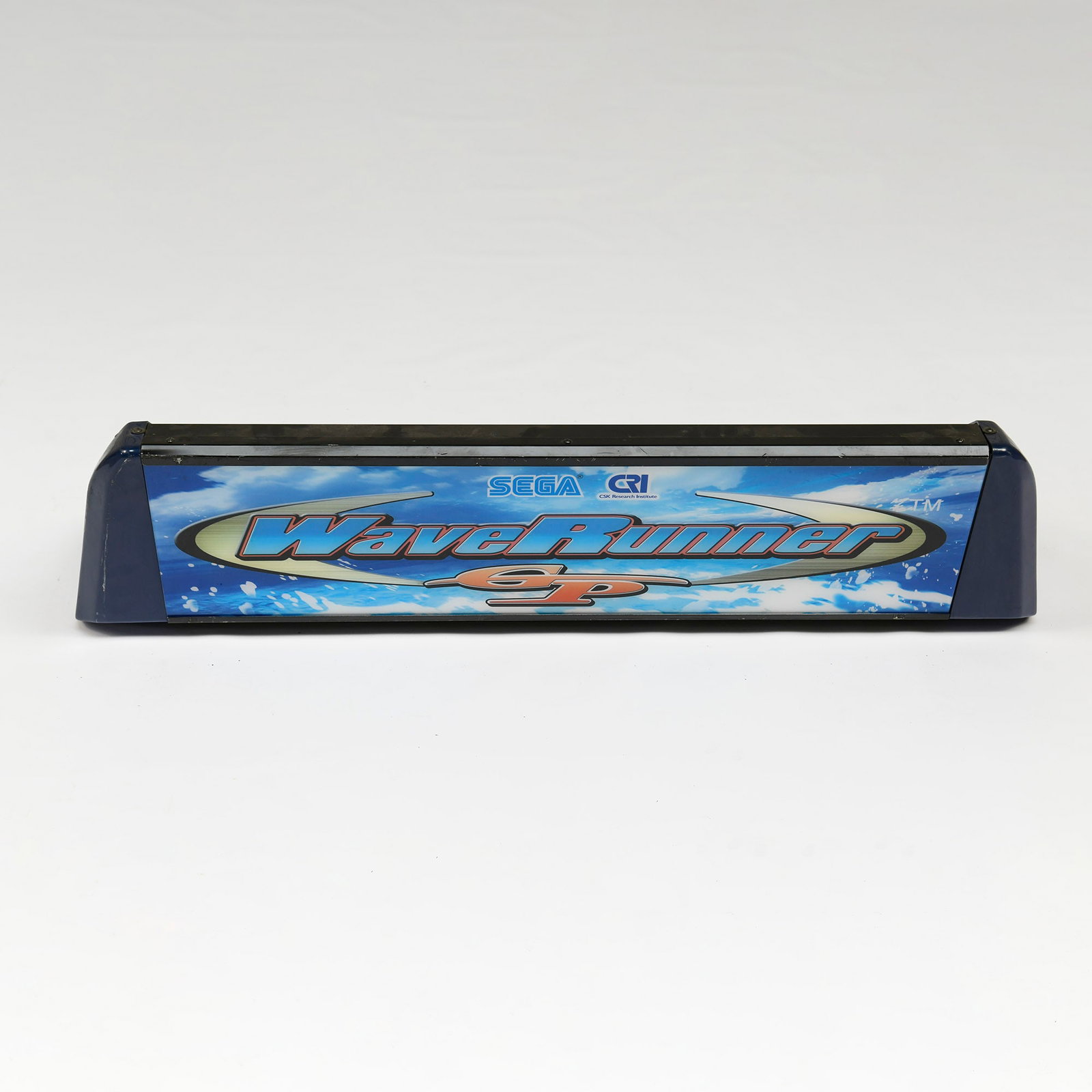 SEGA WaveRunner GP Arcade Marquee: This item is identified as a SEGA WaveRunner GP arcade marquee, featuring prominent branding and a vibrant blue sky and wave graphic. Visually, the main display panel appears well-preserved with clear