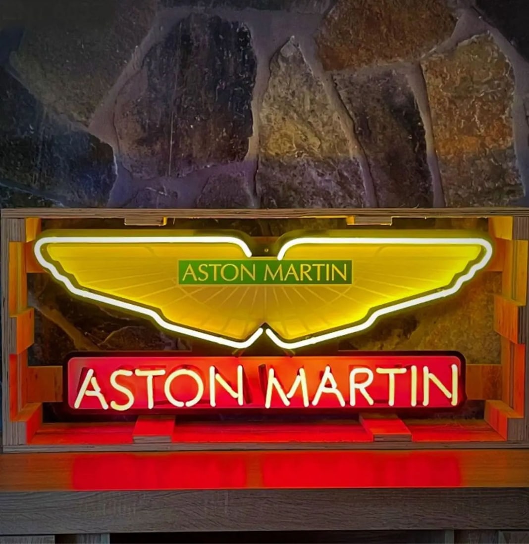 Large Aston Martin Logo Neon Sign with Printed Back Plate: Large Aston Martin logo real glass tube neon sign with printed back plate. The colorful printed back plate ensures that the neon sign looks great whether it's powered on or off. It is in excellent, li