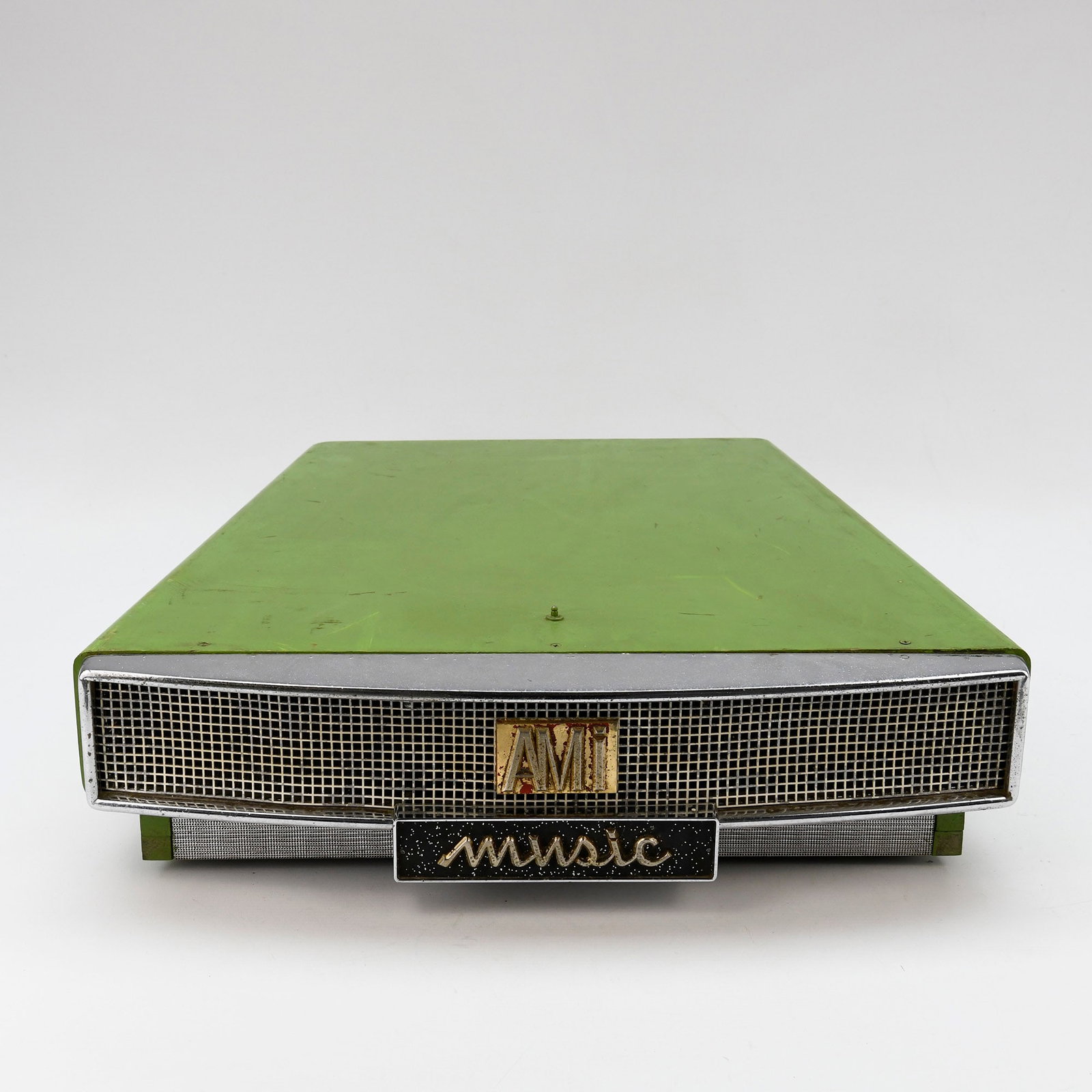 Original Ami Model G Jukebox Horn: Original Ami Model G Jukebox Horn. The unit is housed in a vibrant green painted metal casing which shows visible signs of wear including scratches, scuffs, and minor paint loss. The chrome trim and g