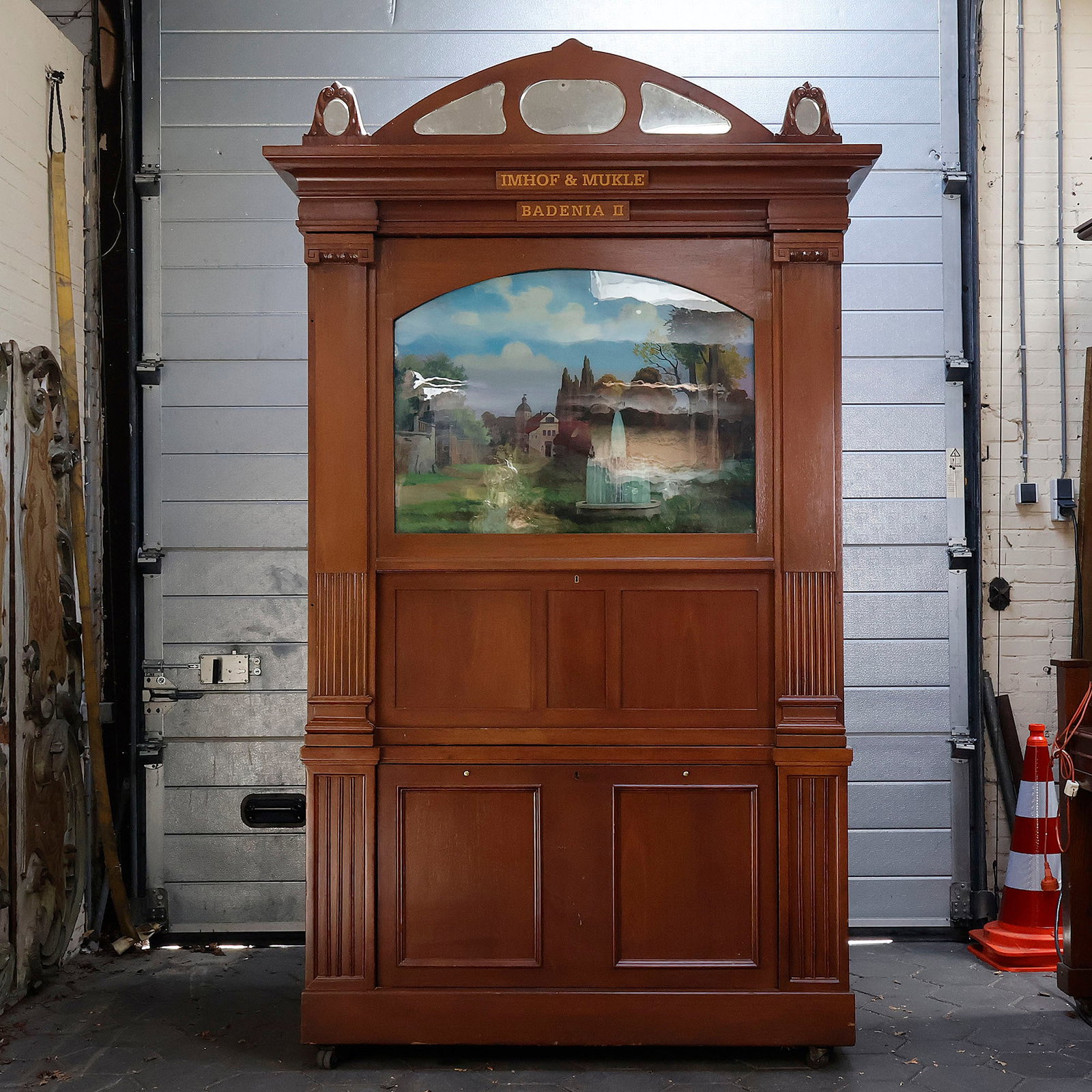 Imhof & Mukle "Badenia II" Orchestrion (Early 20th Century): This "Badenia II" automatic orchestrion was manufactured by Imhof & Mukle in Vöhrenbach, Germany, during the early 20th century. Housed in a tall wooden cabinet, the upper front features a framed gla