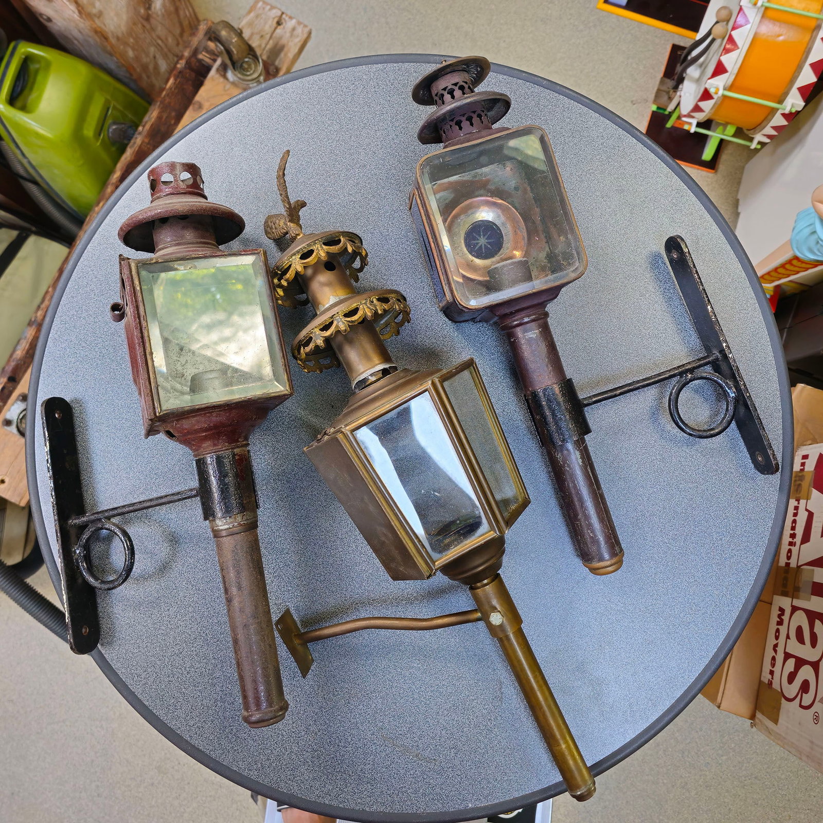 Set of 3 Antique European Carriage Lamps from the G. Perlee Workshop: This is a set of three antique carriage lamps, from the G. Perlee workshop, likely dating from the late 19th or early 20th century. One lamp is brass-toned with an ornate, crown-like decorative elemen