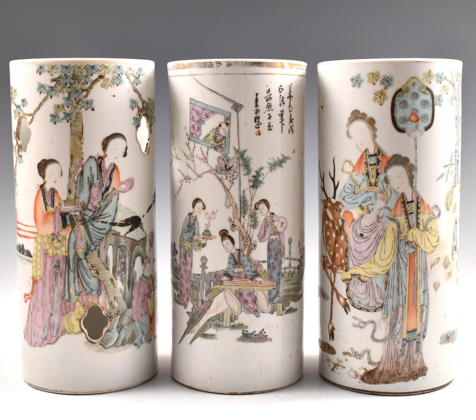 3 PCS CHINESE FAMILLE ROSE HAT HOLDERS: Dimensions: H 11” 3 Pcs Chinese Famille Rose Hat Holder. Each in tall cylindrical shaped body. The exterior painted with ladies in pursuits within tropical landscape and architectural scene. The