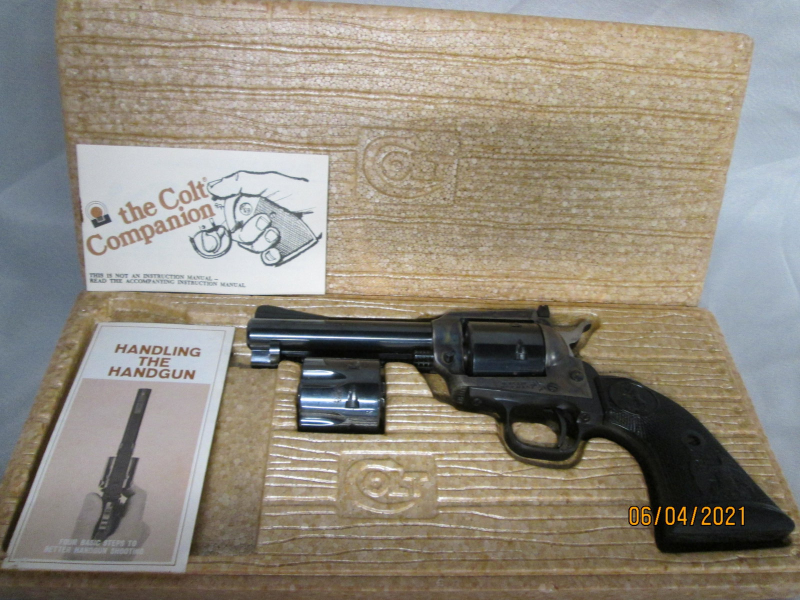 Colt New Frontier 22LR / 22WMR Revolver: Colt New Frontier 22 Revolver. (2) Cylinders 22LR & 22WMR . similar features as Peacemaker Model, except with flat-top frame, ramp front and adj. rear sight, convertible, Case Hardened, inside part of