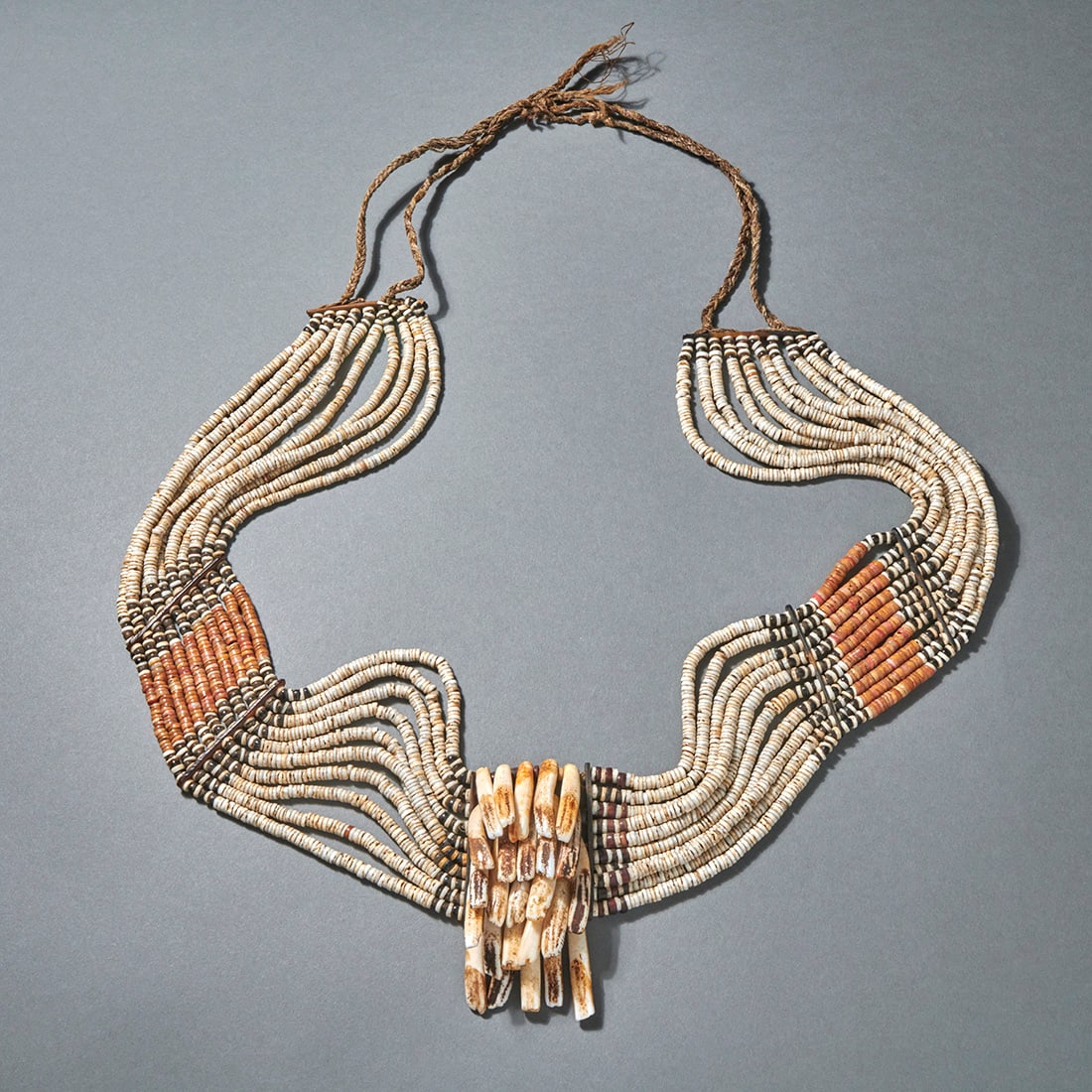 A Solomon Islands belt, Fo’o’aba: Kwara’ae, Malaita, Solomon Islands, 19th Century, white galu, red fira’i & black fulu money beads, dolphin teeth, turtle shell & fibre. Lg. of beaded band 28 3/4 in. 74 cm. Provenance: Galerie Lem