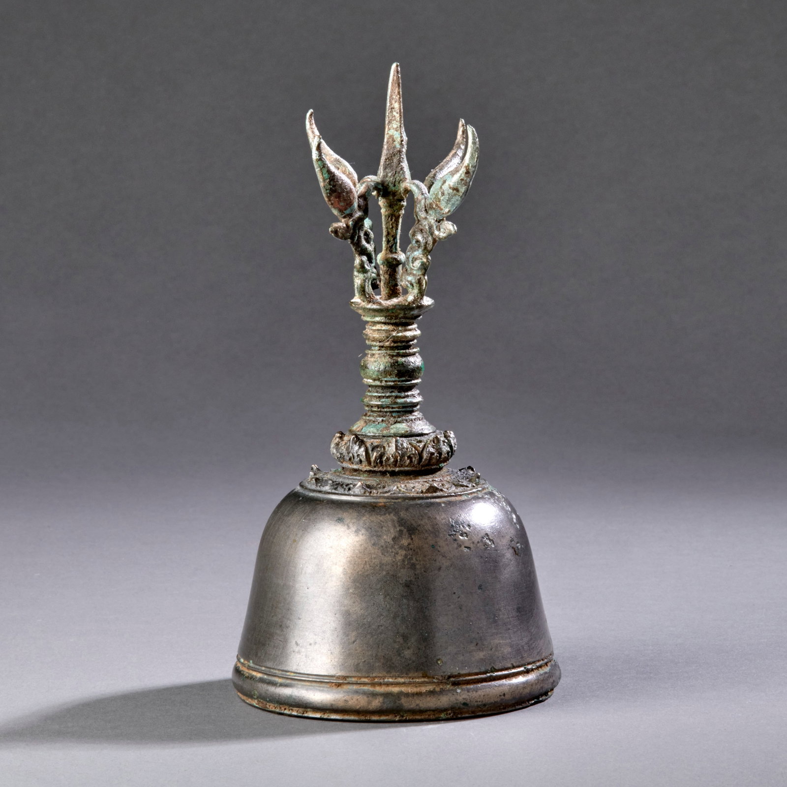 A Javanese Handbell: Eastern Javanese period, circa 13th century, the bell with vajra finial (vajraghanta), the outward-curving prongs typical of this period. As with many of the better Japanese bells, this example has a 