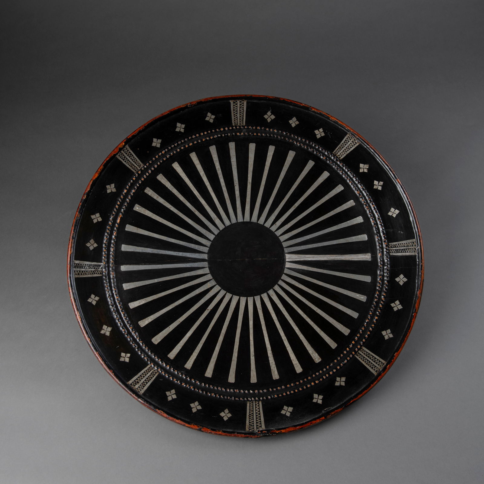 A Vietnamese war shield: Vietnam, Kontum Highlands, Seang/Jarai people, late 19th Century, wood, cane, fiber, lacquer & pigments, some restoration to a crack. Dia. 19 3/4 in. 50 cm. Provenance: Charles Derby collection, North