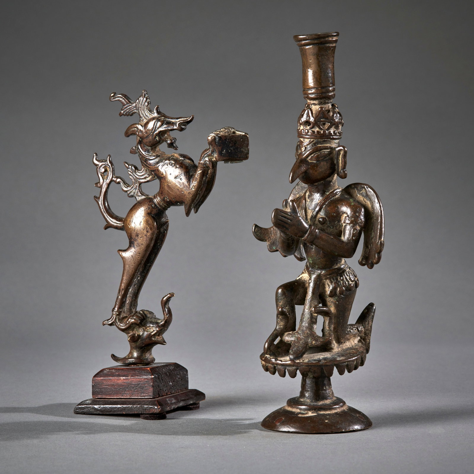 Two Indian Bronze Figures: Circa 16th/18th century, a circa 16th century figure of a kneeling Garuda surmounted by an incense or candle holder, with a circa 18th century fragment of a lamp in the form of a rampant Vyala standin