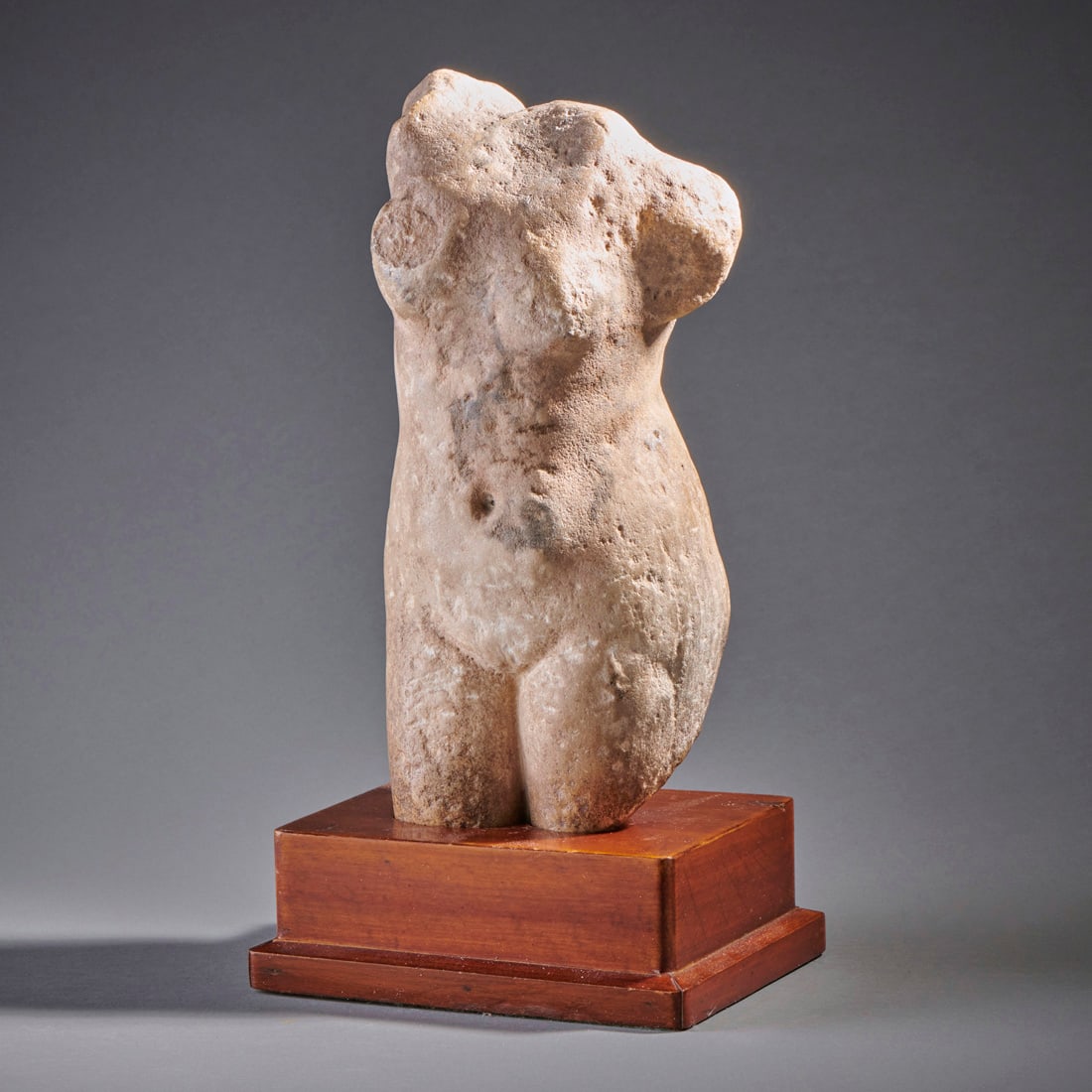 A Roman Marble Female Torso: Circa 2nd-3rd century A.D., possibly a depiction of Venus. Losses and pitting. Ht. 13 in. with stand. Shipping within the continental U.S. is $70.
