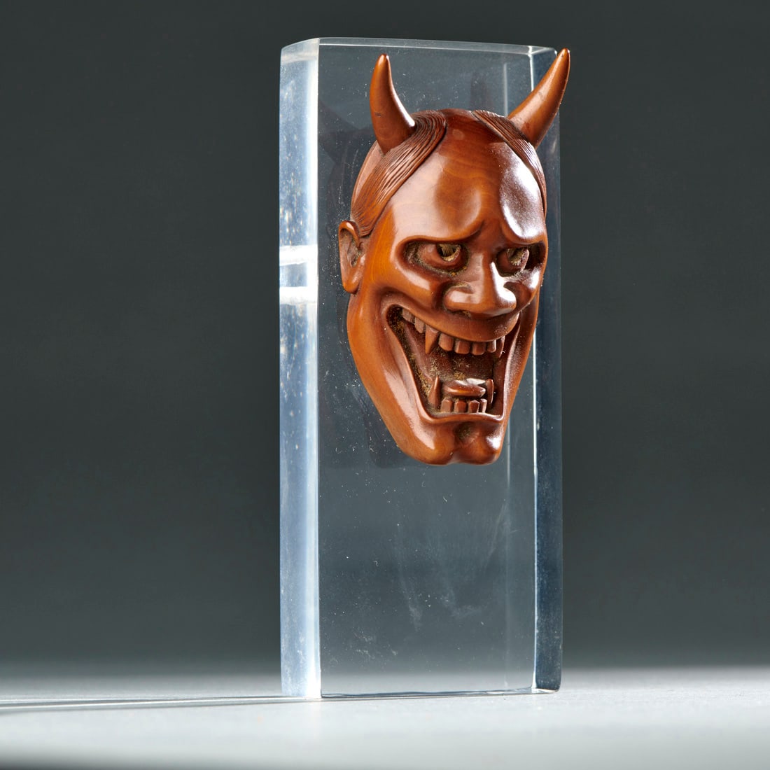 A Japanese Boxwood Netsuke: Japan, Meiji period, circa 1890, well carved image, on custom stand. Fine condition. Ht. 2 1/2 in. Provenance: Private collection, Baltimore, MD; purchased at Holbrook Gallery, Santa Fe, New Mexico, 1