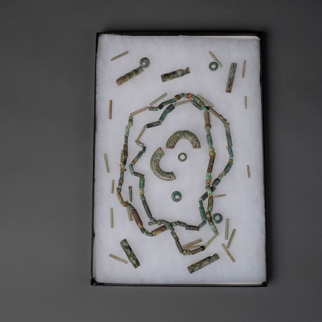 A collection of Pre-Columbian jade necklace beads: Mayan and Peruvian, tube and round beads together with larger pendant elements. Provenance: Private collection, Santa Fe, New Mexico; Norman Hurst Gallery, Cambridge, Massachusetts.