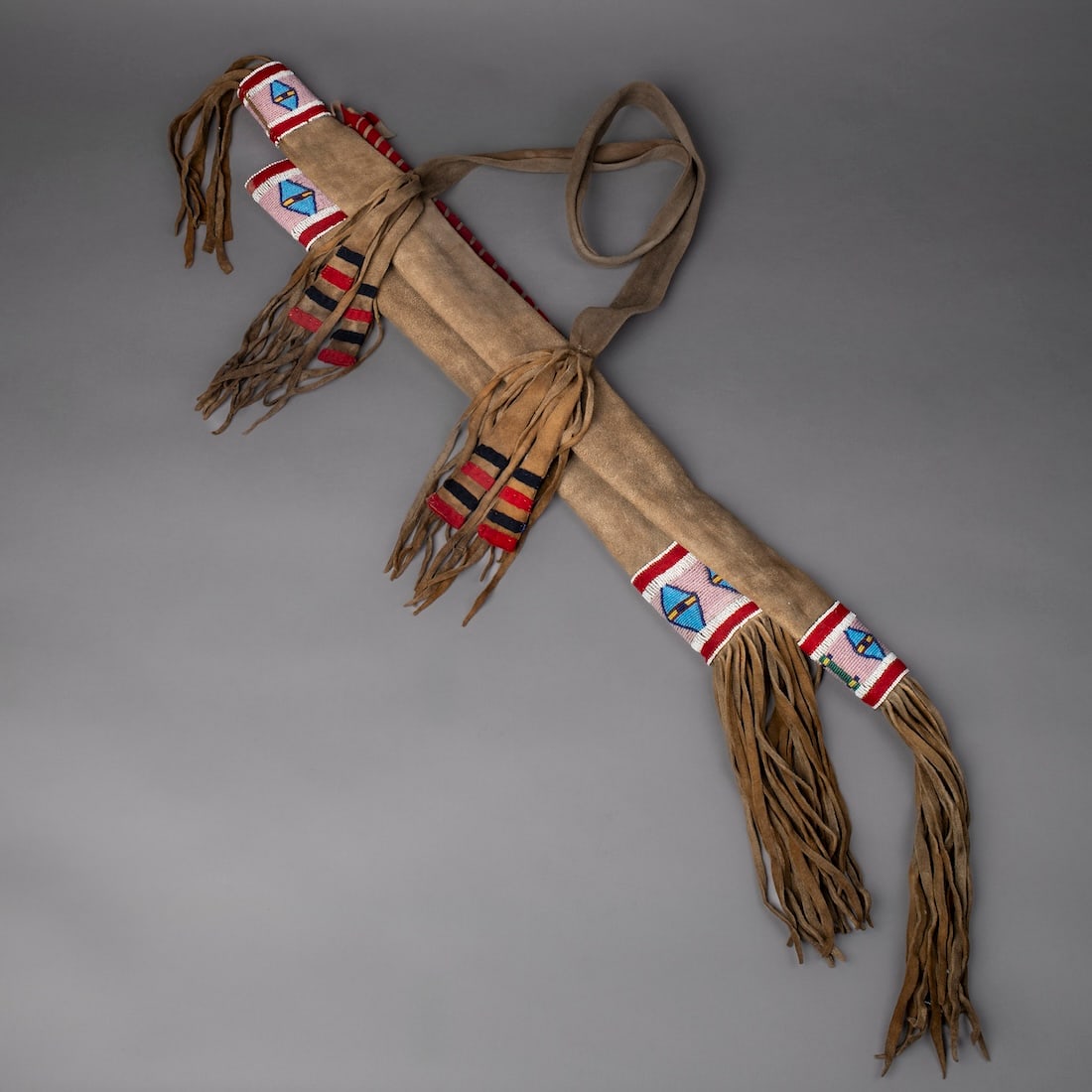 A Northern Plains style beaded hide bow case & quiver: 20th century, sinew sewn Inter-Montane (Nez Perce) style beadwork bow case and quiver on heavy brain tanned hide. Lg. of quiver without fringe 33, lg. of bowcase without fringe 25 in.