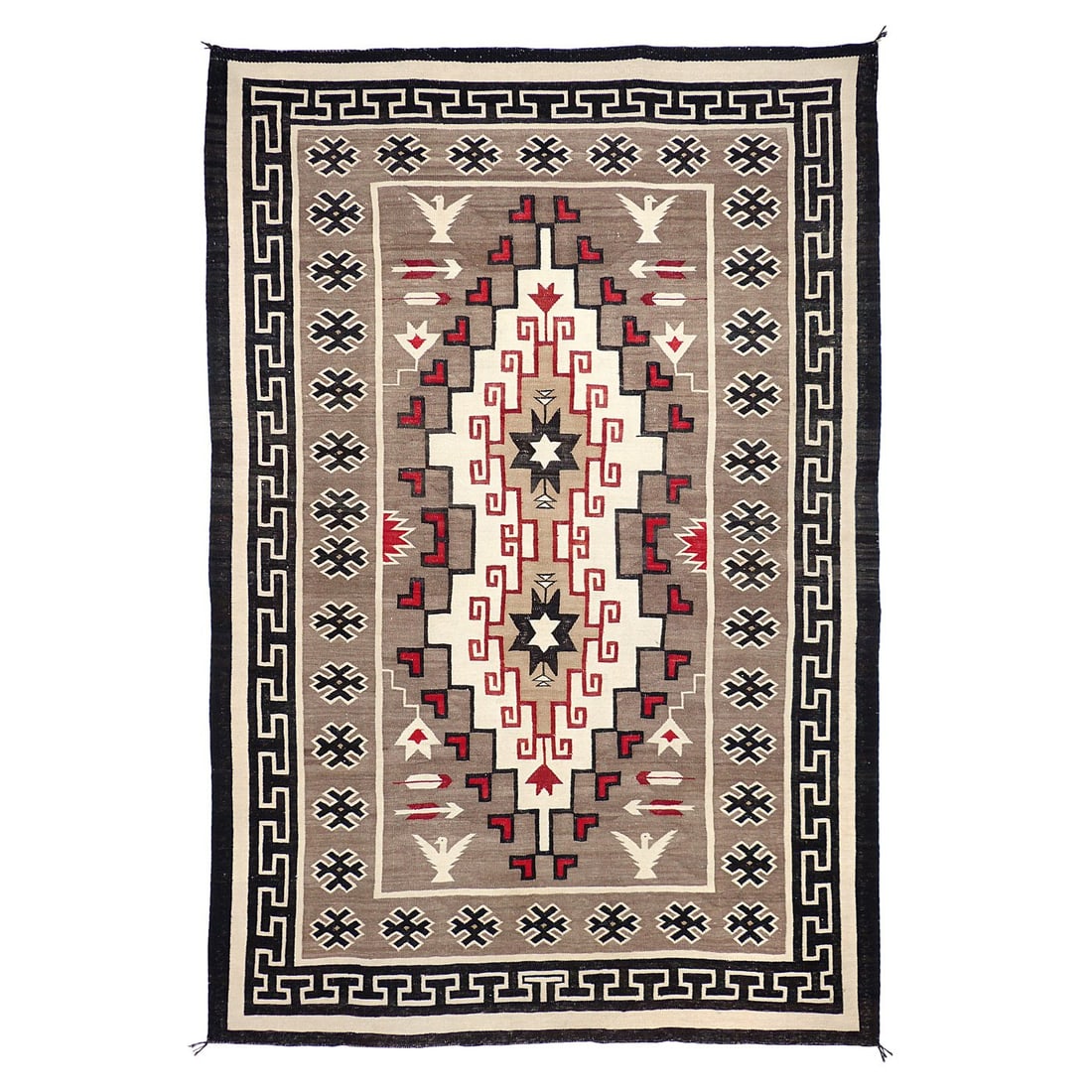A Navajo (Diné) Klagetoh Rug with Bird and Arrow Motifs: Circa 1940s, the black border with key border within, the typical complex central diamond pattern, with birds and arrows on a grey ground. 80 x 54 in.