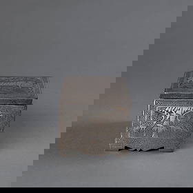 A Korean silver engraved box: 19th century, the rectangular iron box decorated on each side and the lid with fine silver engravings of animal scenes, each framed with a rectangular key border. Ht. 3, wd. 3 ½, lg. 4 ½