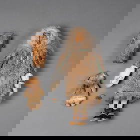 A contemporary Eskimo doll by Ethel Washington: Mother and child, by Ethel Washington (1889-1968), the mother with a painted face carved with birchwood, traditionally crafted with a carved wooden face, fur parka, and hide boots. Detailed with dyed