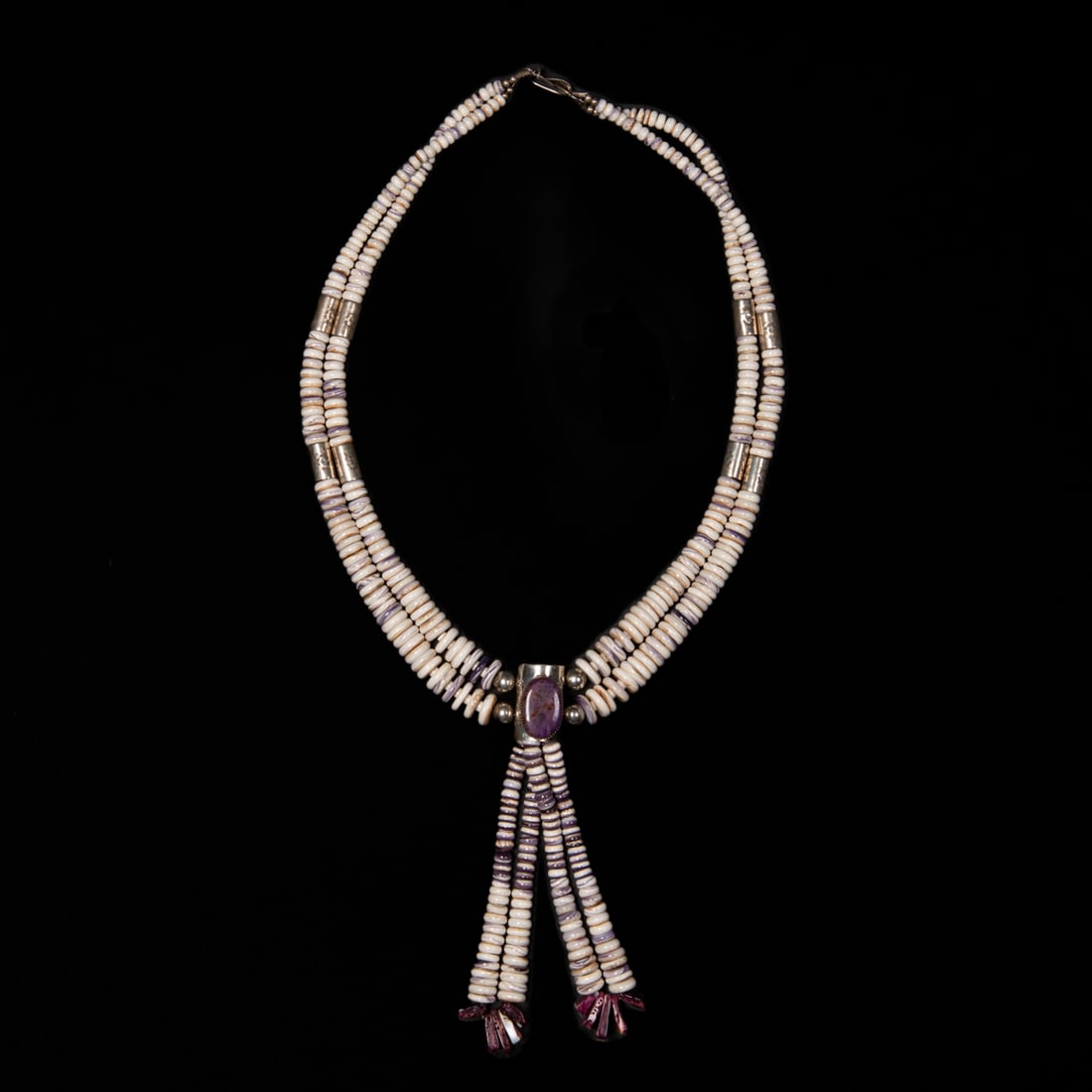 A collection of Southwest necklaces: Six necklaces, one with beaded and bone turtles, two coral necklaces, a multicolored stone necklace, a three-strand bead necklace and a large silver and stone disk necklace with two jacla, marked, “