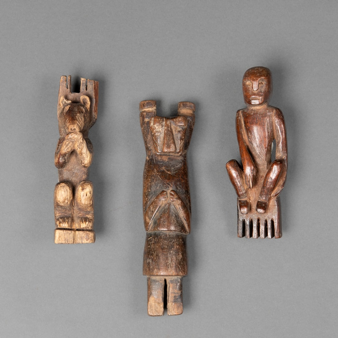 Three Guatemalan slingshot effigies: Carved hardwood figures depicting a squirrel, a human figure, and a human-jaguar transformation. Each shows distinct folk carving traits with expressive stylization. Lg. 5, 4, and 4, in.