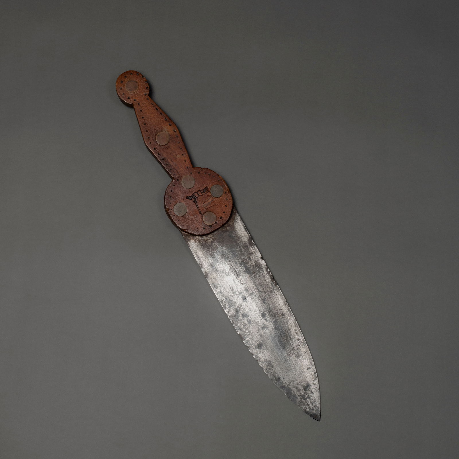 A Baldwin Hill & Company trade dag knife: Fourth quarter 19th century, featuring a forged Baldwin Hill & Company New York Cast Steel, blade and a custom hardwood handle with large brass rivets and finely dotted decoration. The circular