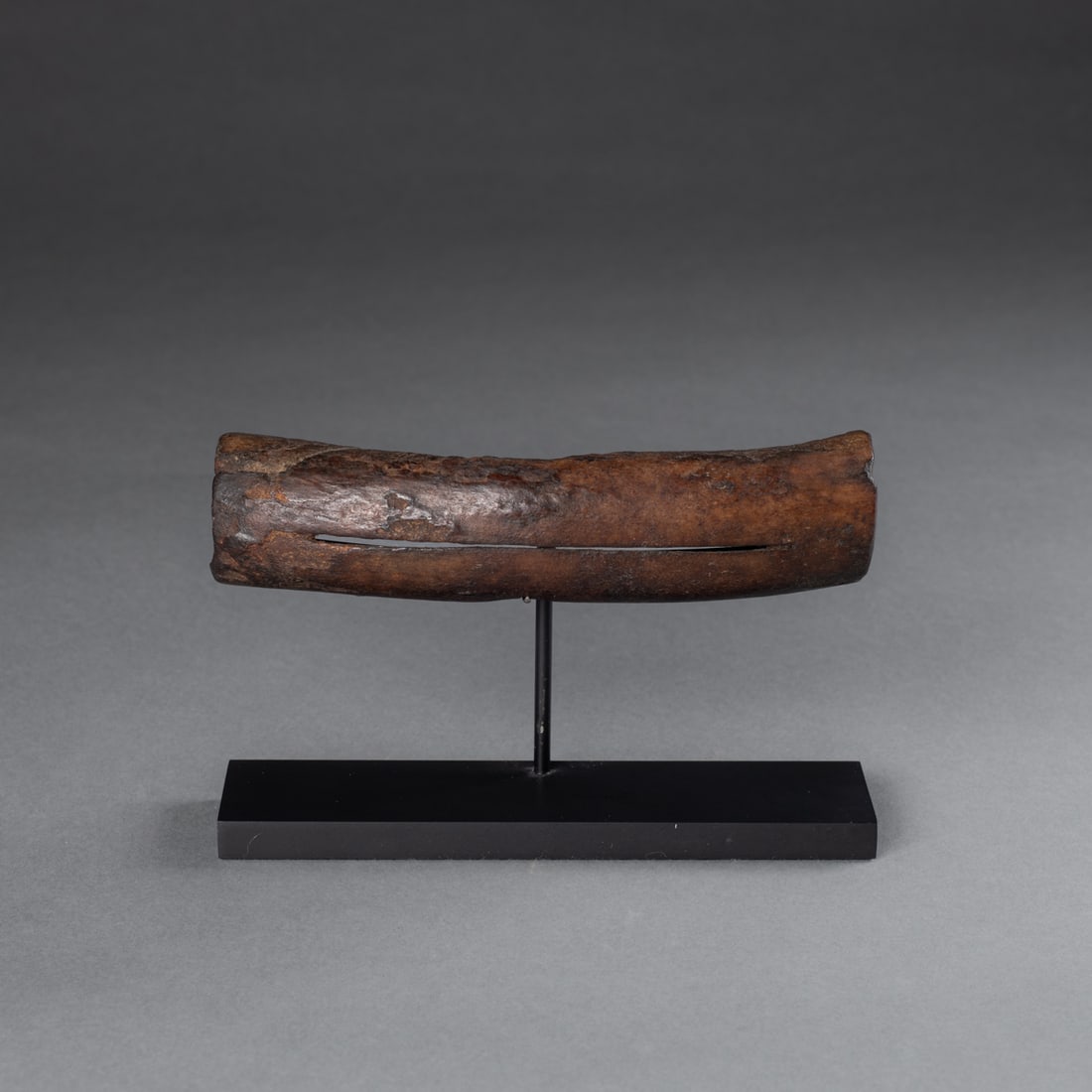 A pair of Eskimo snow goggles: Alaska, 19th century or earlier, made from bone, with metal stand. Wd. 6, ht. 1 3/8 in. Provenance: Private collection, Albuquerque, NM.