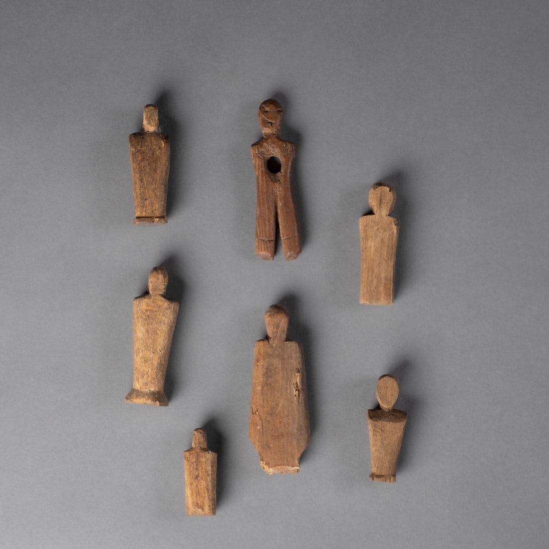 Seven small wood Eskimo torsos: Alaska, 19th century, seven carved wood torso figures, each with dry patina. Lg. 3, 2 3/4, 2 1/2, 2 1/4, 2 1/4, 2, and 1 1/2 in.