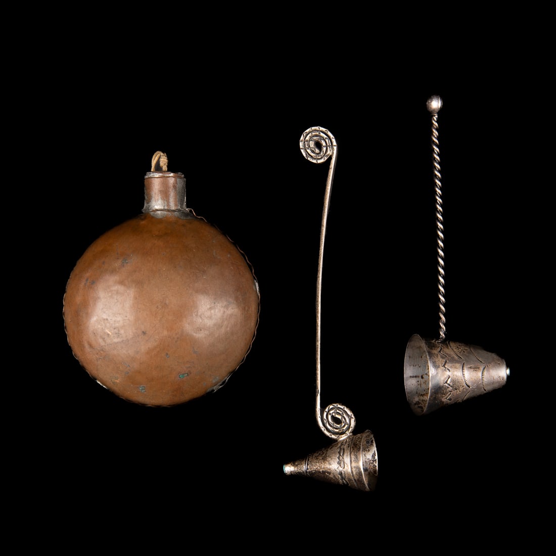 A copper canteen and two candle snuffers: Two silver candle snuffers with stamp work designs and a single turquoise setting atop the cone, with a copper canteen. Lg. 5 1/8, 4 3/8, and 3 1/4 x 2 1/2 in.
