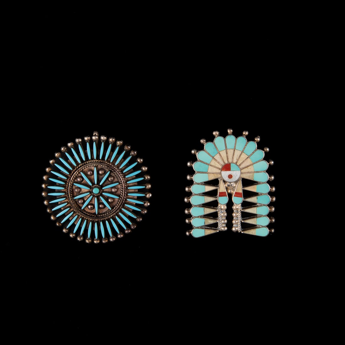 Two Zuni silver and turquoise pins: A circular pin with petit point turquoise and silver balls, marked, "F Pablito Zuni," and a turquoise, coral and shell inlay pin marked, "Fabian Collection Zuni." Dia. 2, and 2 x 1 1/2 in.