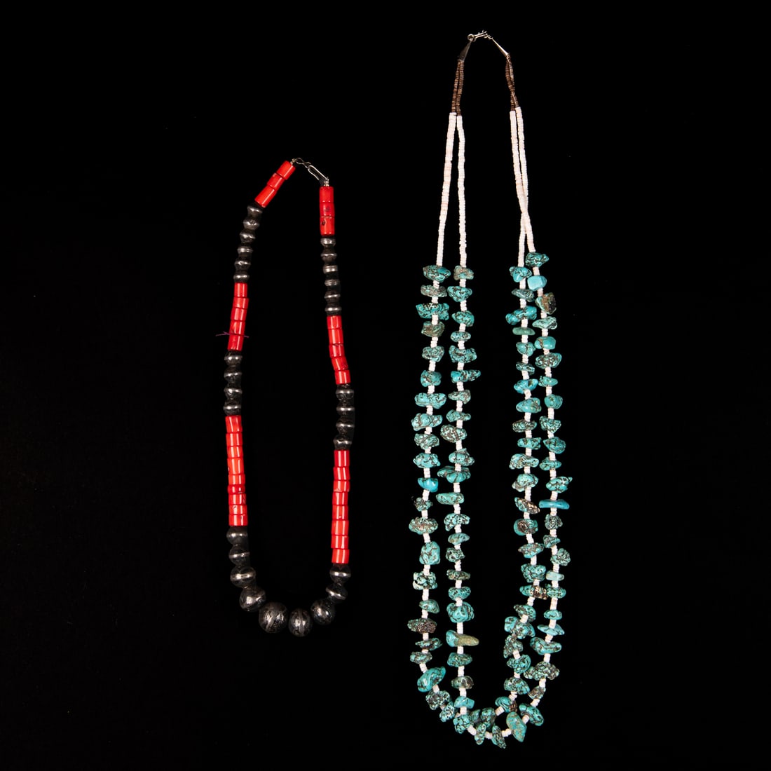 Two Southwest necklaces: A two-strand turquoise nugget and heishi bead necklace with sterling tin cones, with a silver and coral bead necklace. Lg. 30 1/2 and 20 in.