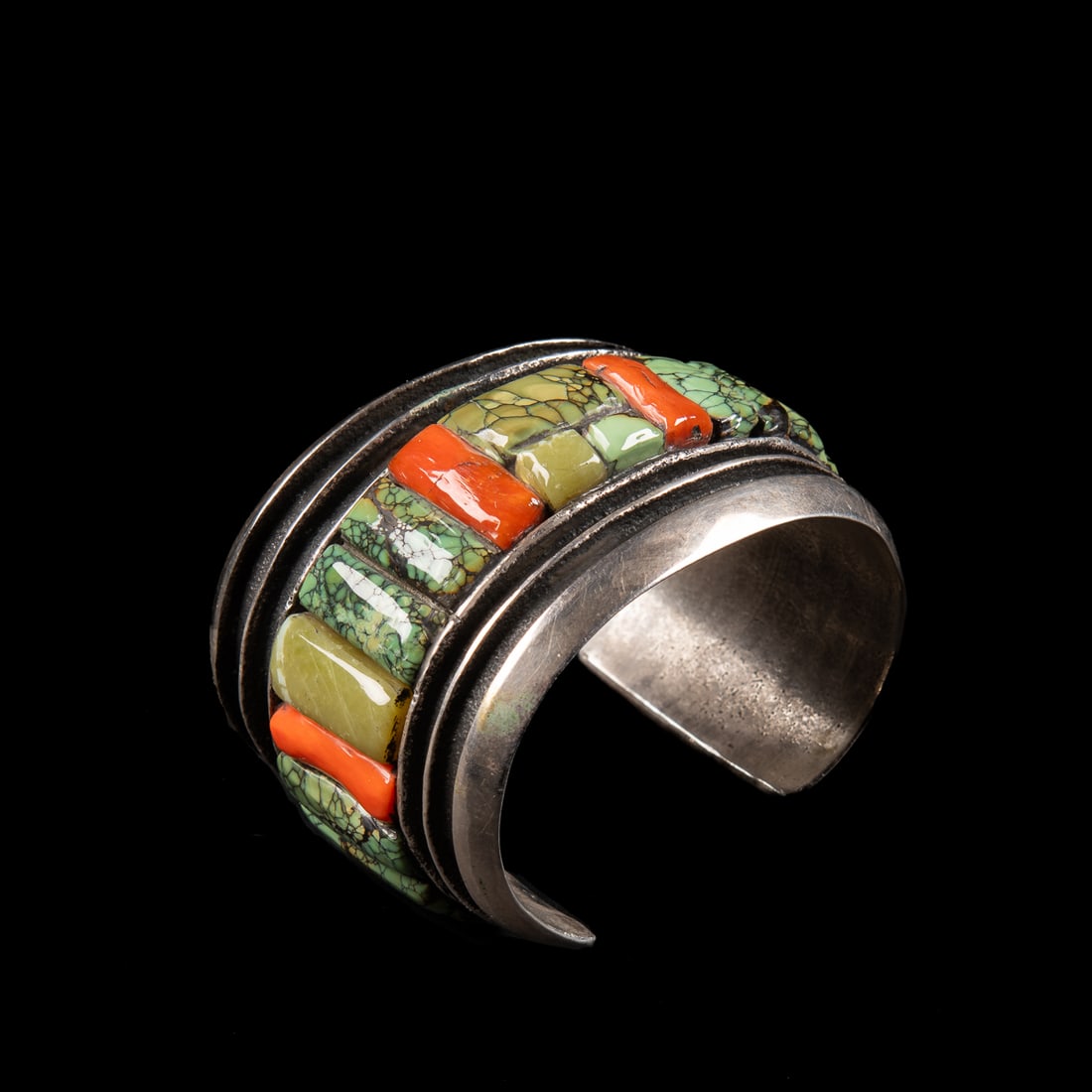 A John Hornbeck silver and turquoise cuff bracelet: John Hornbeck (Anglo), the wide tufa cast silver cuff with turquoise and coral settings, stamped with the Hornbech hoof markings. Total interior circumference (including gap) 6 5/8, wd. 2, gap 1 1/4 i
