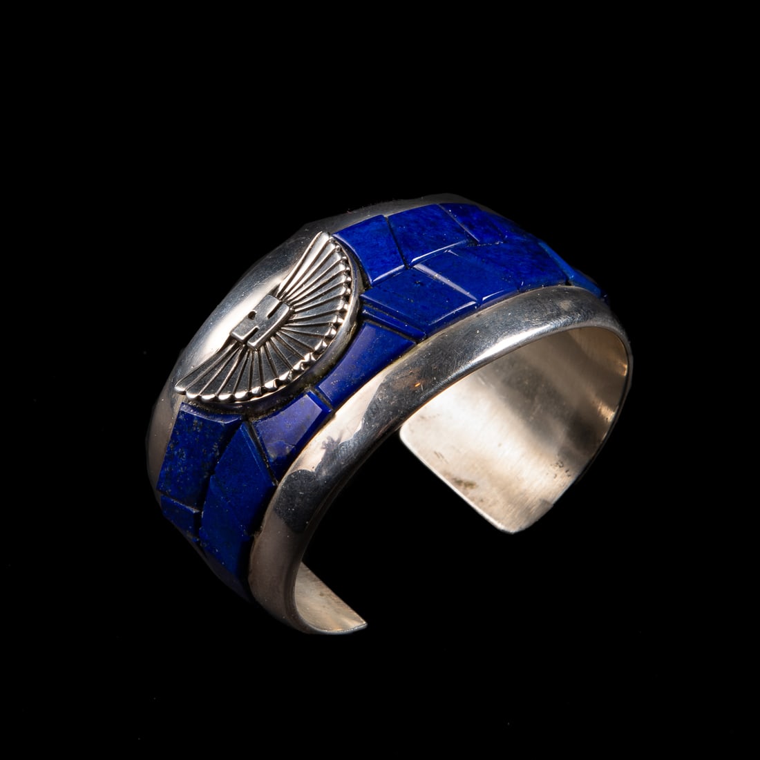 A Michael Garcia silver and lapis cuff bracelet: Michael Garcia "Na Na Ping" (Pascua Yaqui). The wide Sterling silver cuff with lapis inlay, signed "Na Na Ping," and marked "Sterling." Total interior circumference (including gap) 6 1/2, wd. 1 3/8,