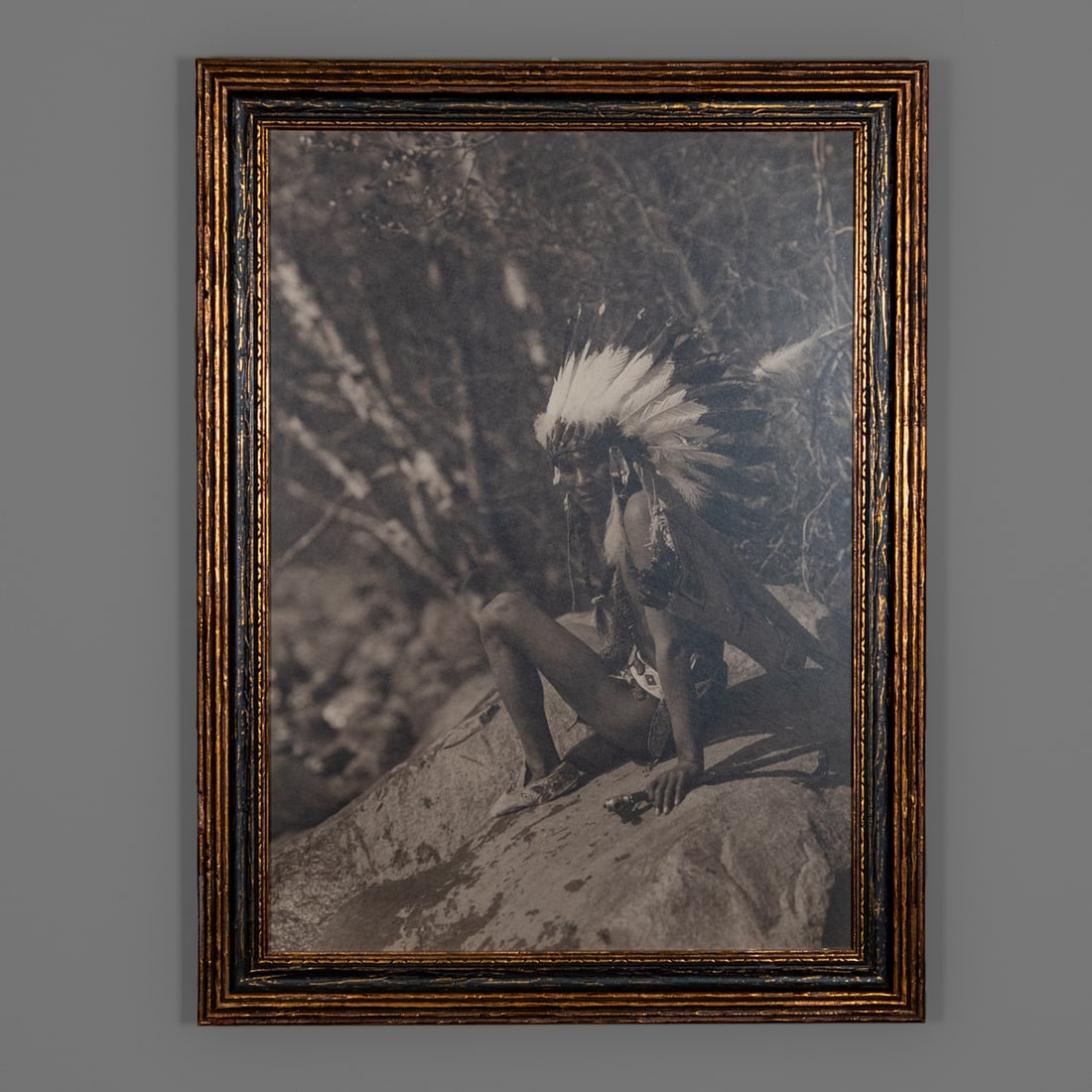 A Roland Reed photograph: Roland (Royal Jr.) W. Reed (June 22, 1864 – December 14, 1934). A silver gelatin portrait of a Native American in a war bonnet, copyrighted 1908 with photographer label, framed. Size of photograph 1