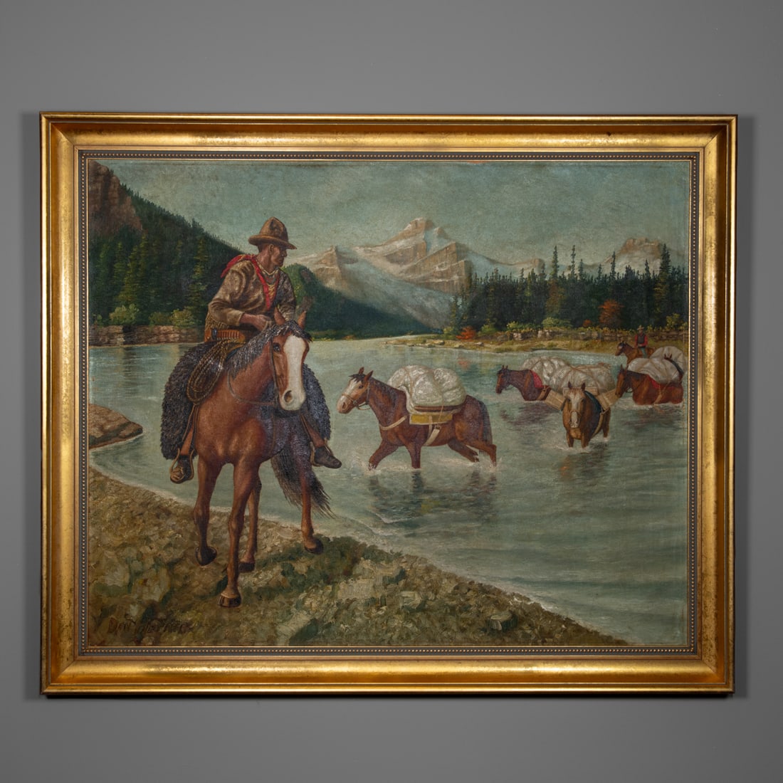 A Western oil on canvas: A detailed Western scene depicting a mounted horseman and a train of pack horses crossing a broad mountain river beneath snow-capped peaks. At the back of the line is another man on a horse,