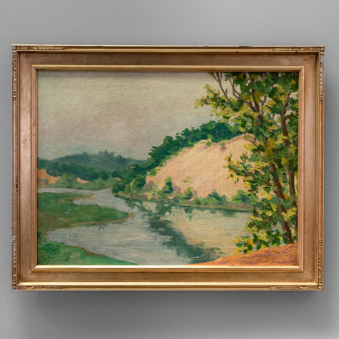 A Simon Horace Pickering Southwestern painting: Oil on canvas depicting a tranquil river winding beneath a tree-covered bluff under a soft overcast sky. Signed lower left “Simon H Pickering” (now partial due to canvas being folded from