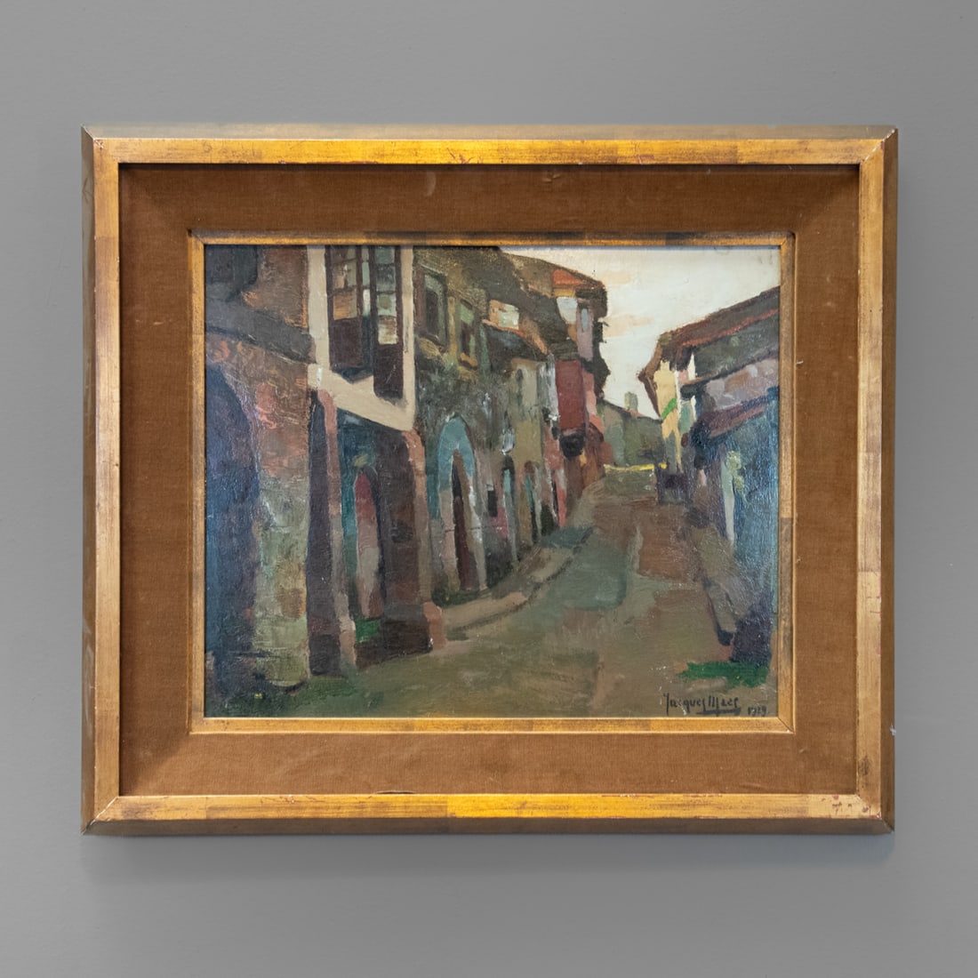 Jaques Maez oil on board: Street scene signed lower right " Maez,", and dated 1929, titled verso "Rue de Villago, Espangna," framed. Size of the painting 15 x 18, size of the frame 24 3/4 x 21 1/2 in.