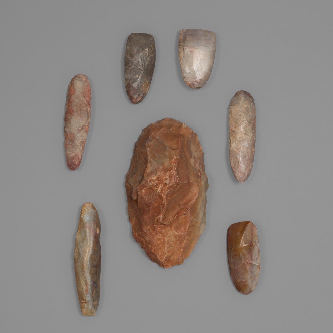 Seven Tilemsi stone tools: Mali, Niger, Chad, ca. 3000-1500 BCE, Tilemsi culture. Lg. 6 ¼, 4 ½., 4, 4, 3, 3, and 2 ½ in. Provenance: The Tom Joyce Collection, Santa Fe, NM.