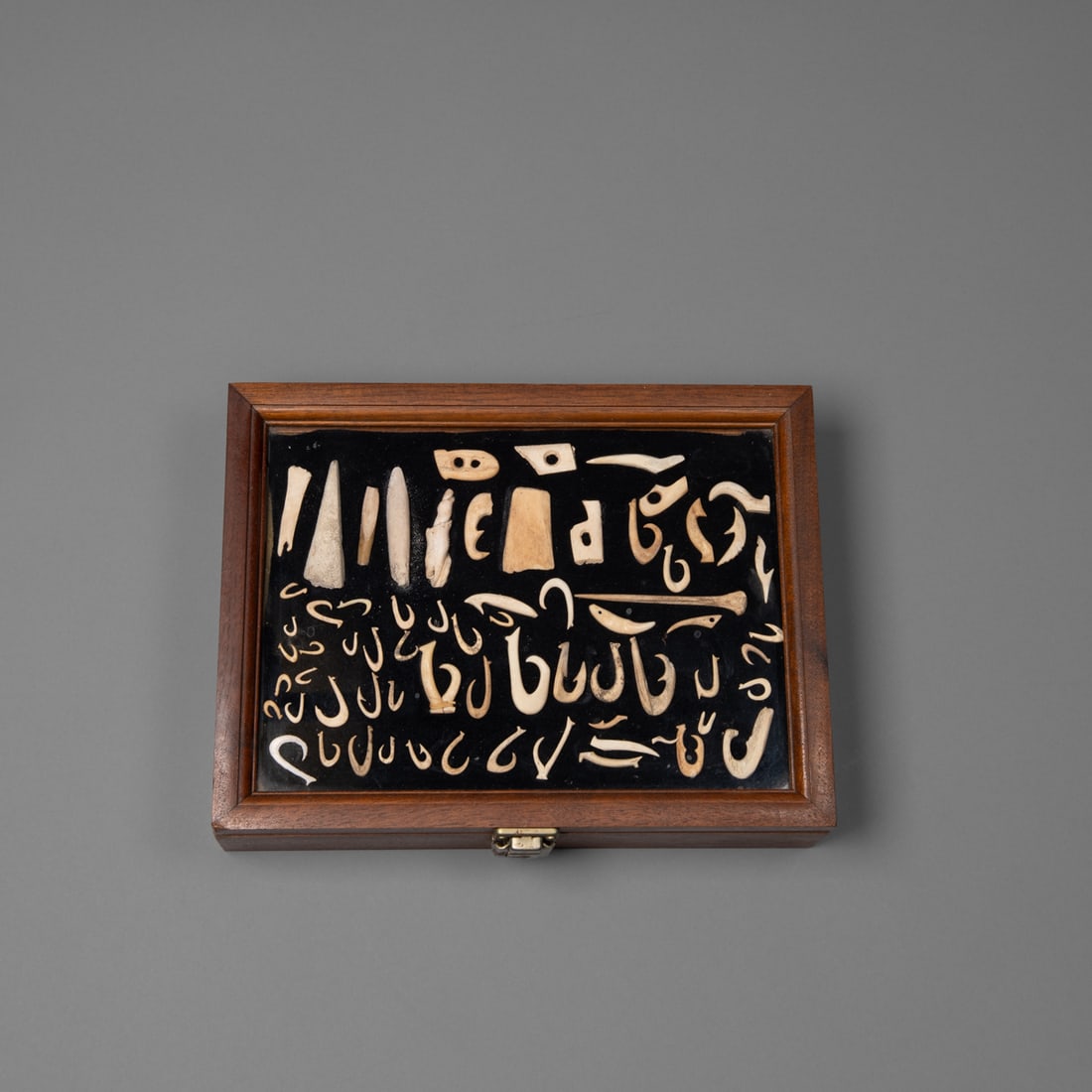 A collection of Hawaiian fishhooks, makau: 19th century or earlier, shell and bone, a large collection of shell and bone fishhooks, shanks, barbs, and tools, including a bone awl and partial hooks. Size of hooks from 3/8 to 1 7/8 in. Provenanc