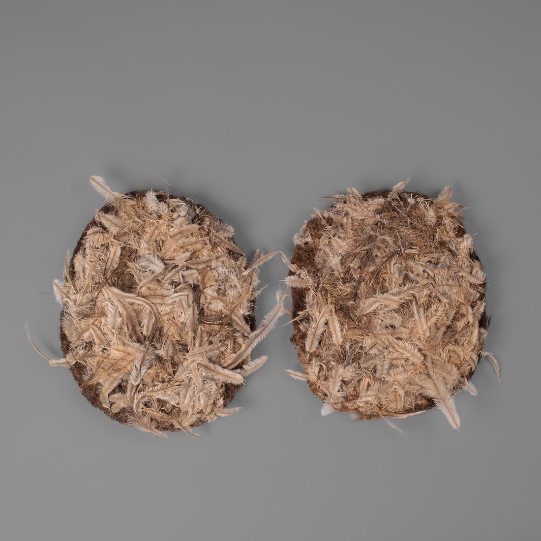 A pair of Aborigine feather shoes: Central desert/ Northern Territory, first half 20th century, the kurdaitcha shoes made from a mat of feathers mixed with human blood and hair. Lg. 10, wd. 8 in. Provenance: Private collection Santa Fe