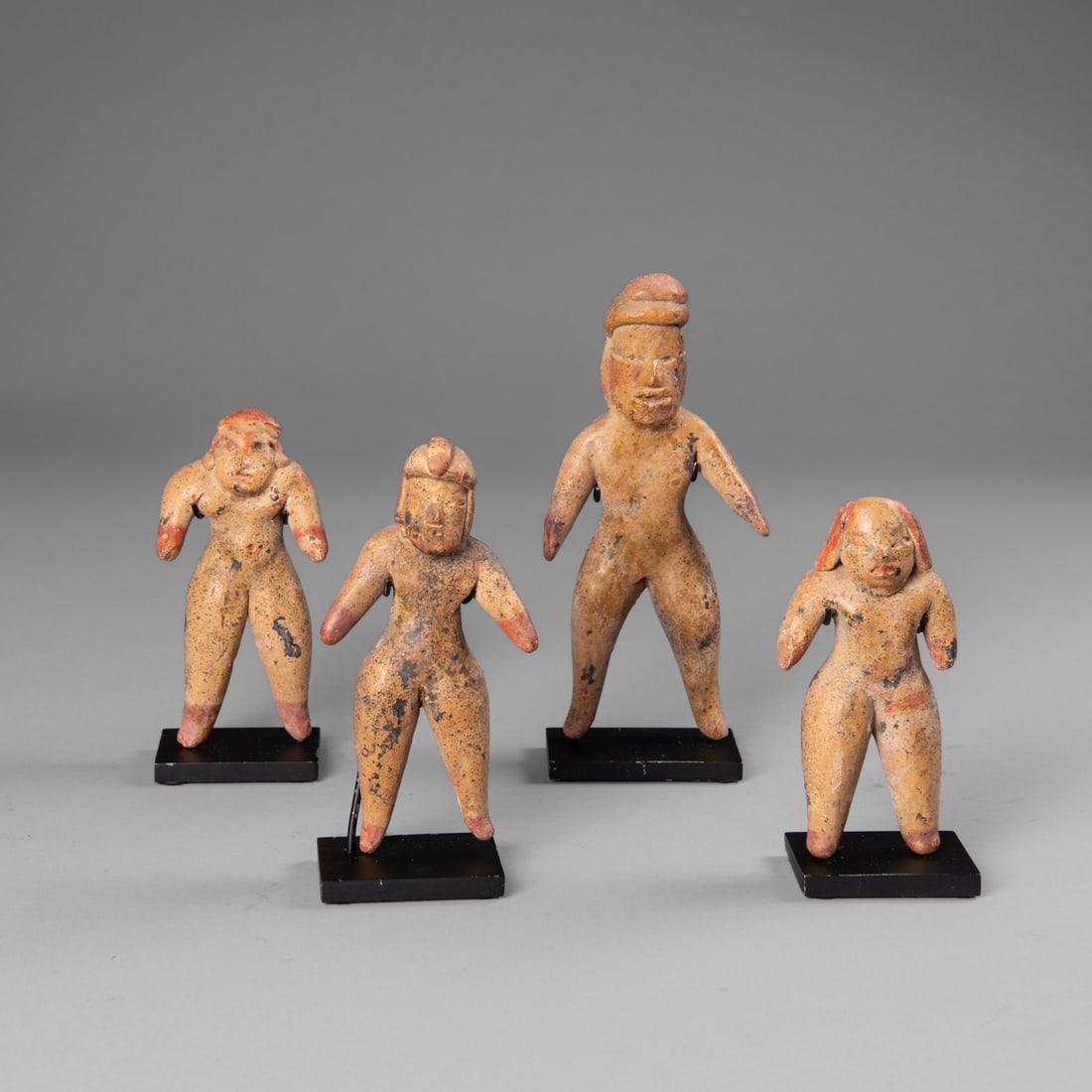 Four Pre-Columbian Las Bocas figures: Olmec, Mexico, circa 1200-900 B.C., each of the ceramic figures portray extended arms to the side with red pigment at hands, legs apart with red pigment at feet, protruding noses, bellies, slit eyes, 