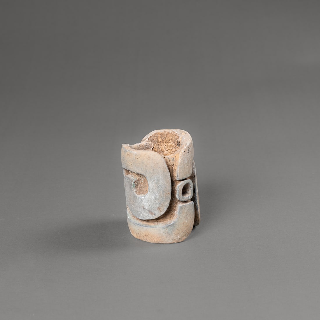 A Pre-Columbian Las Bocas seal: Mexico, the ceramic seal with thick banded spiral motif, with mirrored symmetry, minor cracks, period inscription reads, “C8138." Ht. 2 7/8, dia. 2 1/8 in. Provenance: Private collection, Albuquerqu