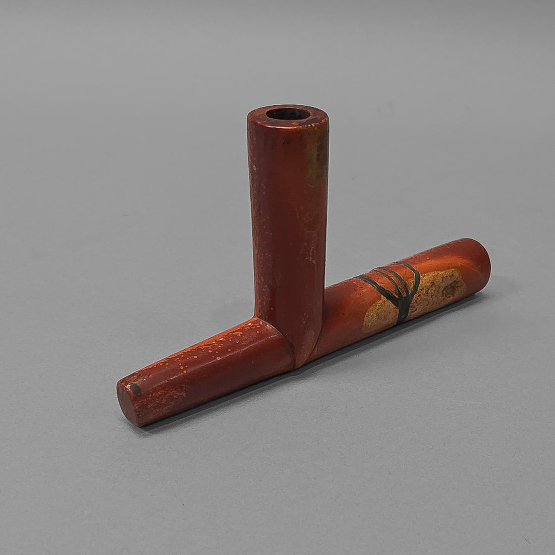 A Plains catlinite pipe bowl: Fourth Quarter 19th Century, the calinite pipe with tall bowl and a lead inlay decoration. Ht. 3 3/4, lg. 6 ½ in.