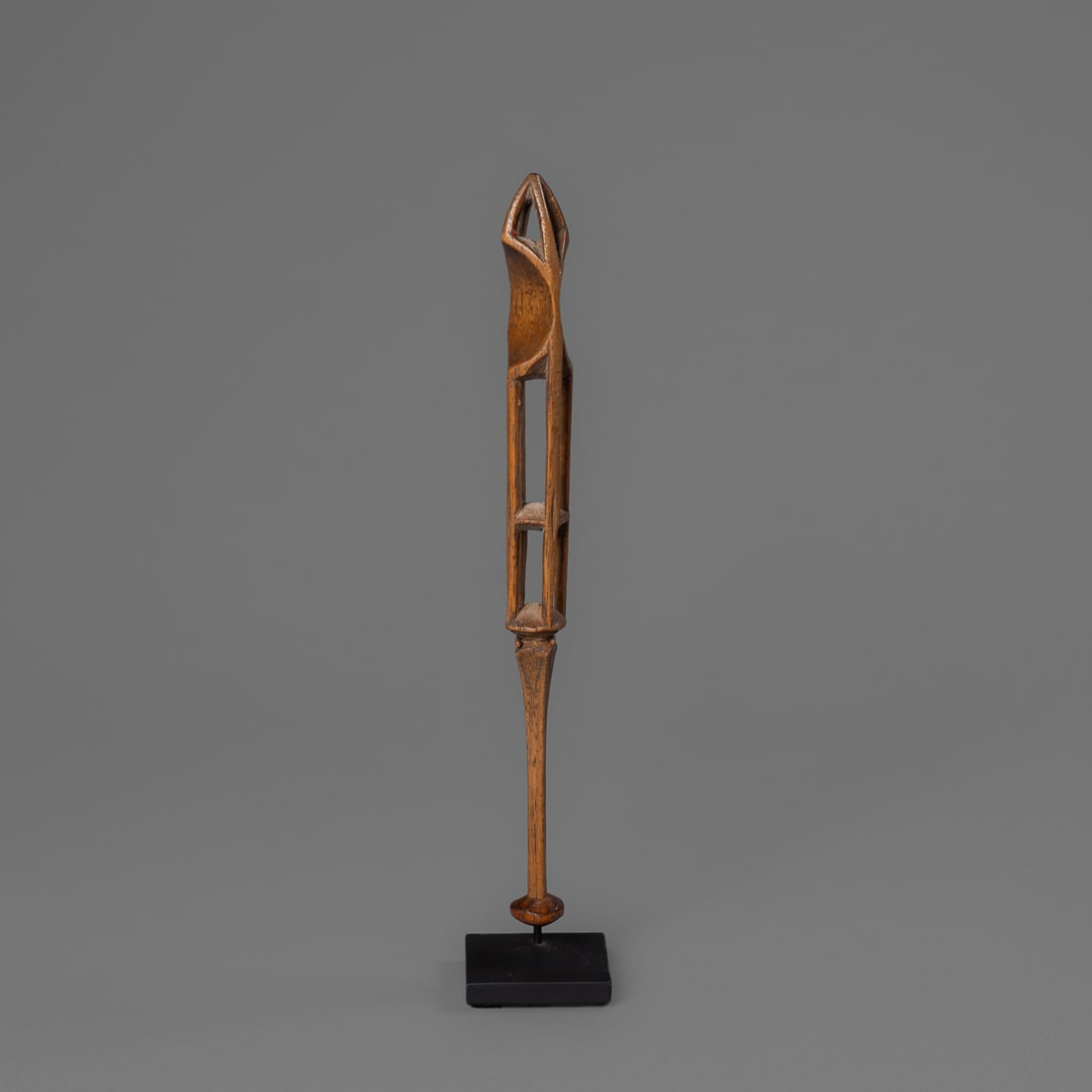 An Iroquois carved cage-form drumstick: 19th century, the carved wooden drumstick with a knobbed, four-sided decorated handle that slowly increases in size, then separates into four thin exterior supports in “caged style.” The cage