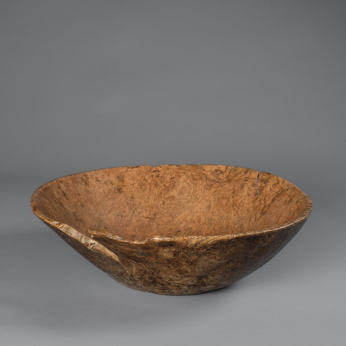 A Woodlands burl bowl: 19th century, the ash burl bowl with a flat bottom, gently flaring sides and soft, rounded rim, (minor wood loss). Ht. 4 1/4, wd. 14 1/2 in. Provenance: Private Collection, Santa Fe, NM; Skip