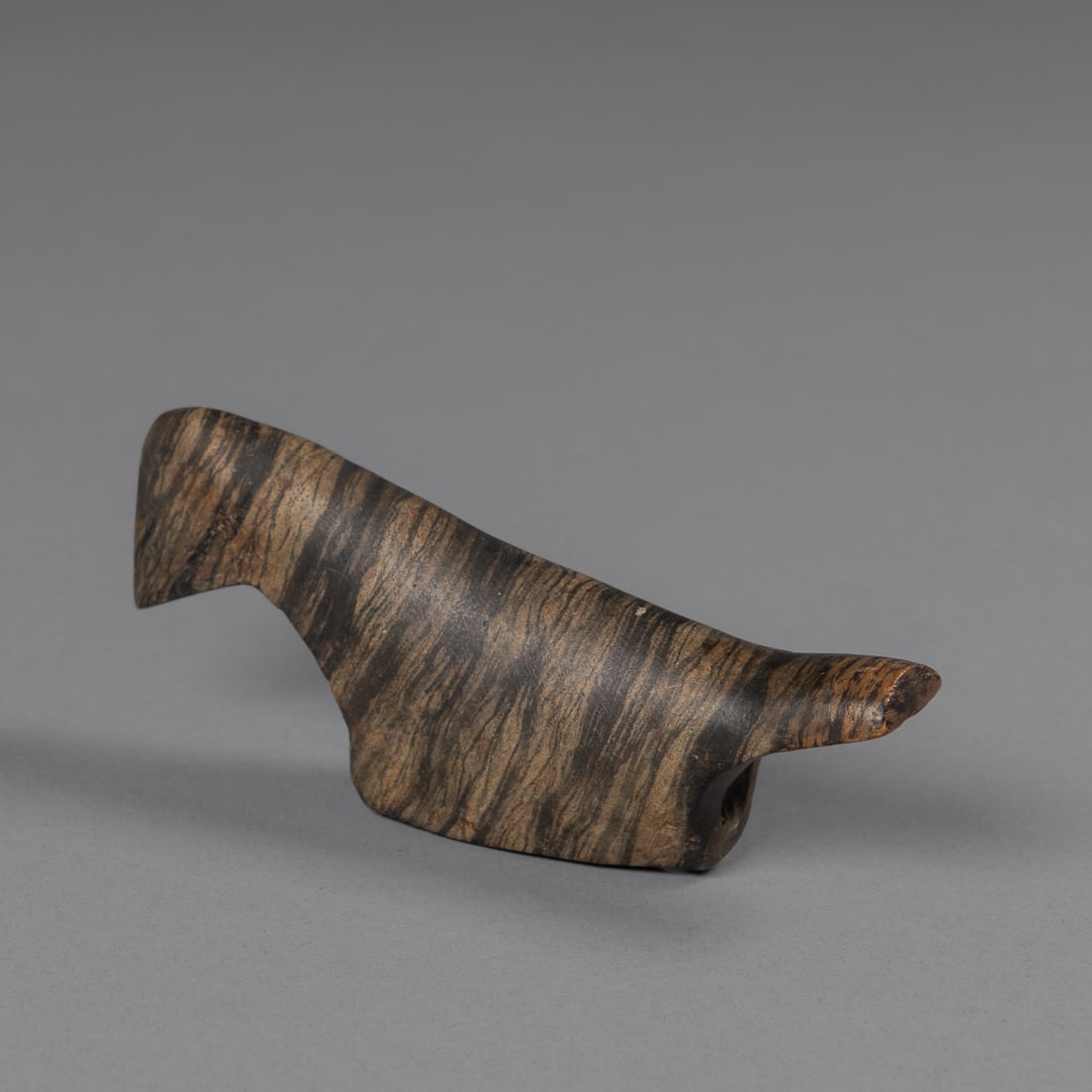 A fine banded slate birdstone: A classic banded slate birdstone, carved from beautifully mottled gray-green and cream banded slate with striking natural color variation running through the body. The piece exhibits the