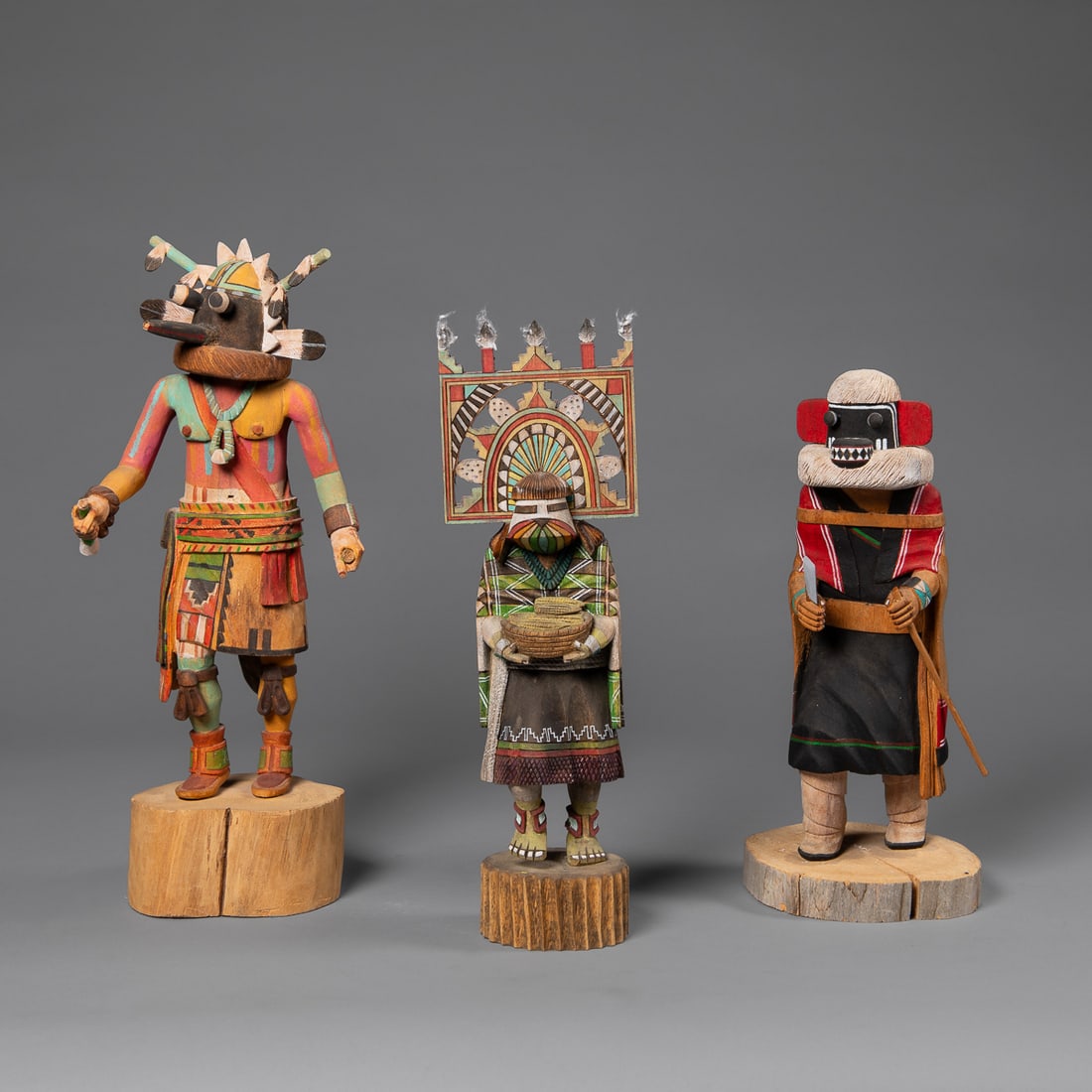 Three contemporary Hopi kachinas: A Butterfly Maiden by H. Jones, a Wupoma kachina by Thomas Takala, and a Stewart Lanza kachina. Ht. 13, 14 1/2, and 12 1/2 in.