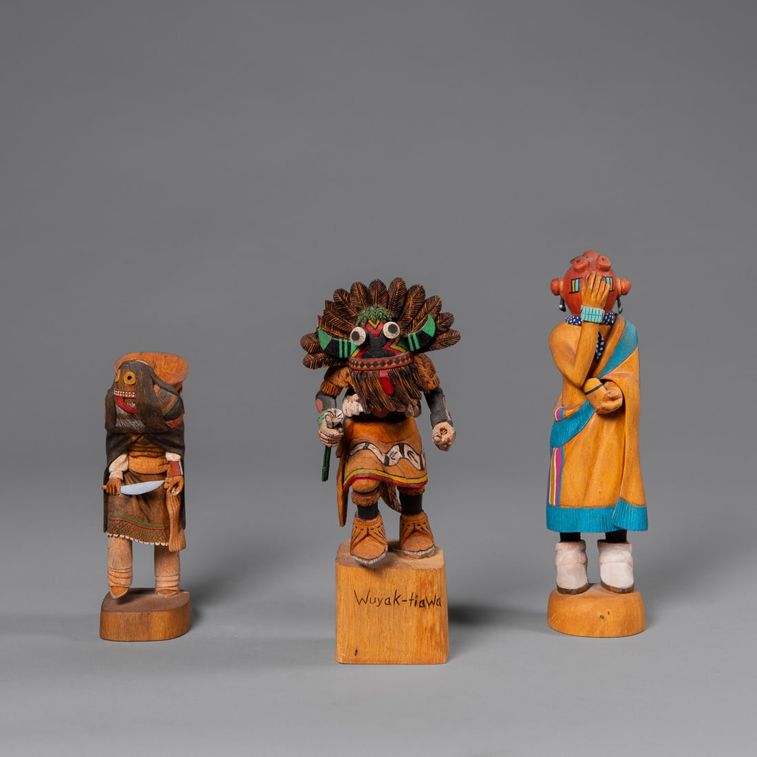 Three contemporary Hopi kachinas: A small unsigned ogre, a Mudhead signed "A.E.L," and a Bred Phillips "Broad Face" kachina from 1991. Ht. 6 1/2, 9, and 8 1/2 in.