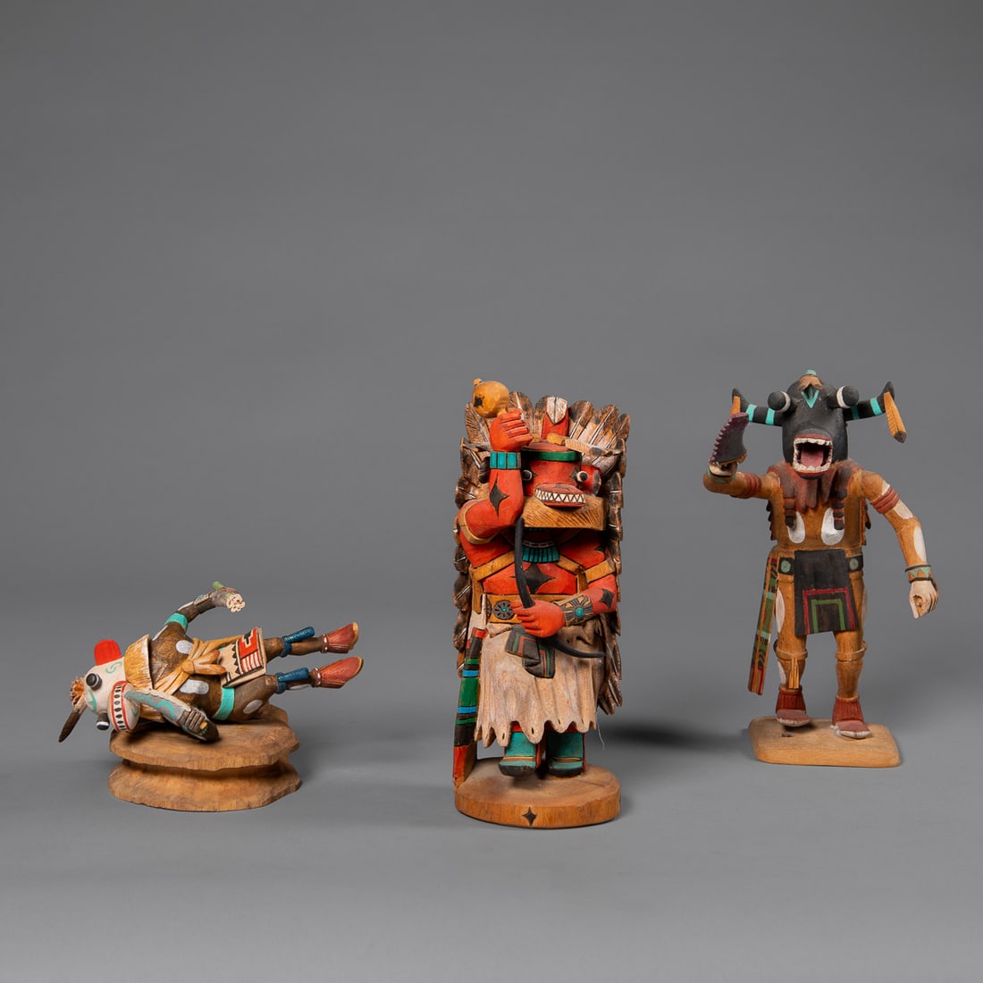 Three contemporary Hopi kachinas: A Harold Polacca Jr Ogre (Tewa) kachina, a L. Tesyatoh A. Hote, Red Bone Kiva kachina, and a David Roy Ogre, 1993 Yok-va kachina, (come away from mount). Ht. 9 1/2, 9, and 8 in.