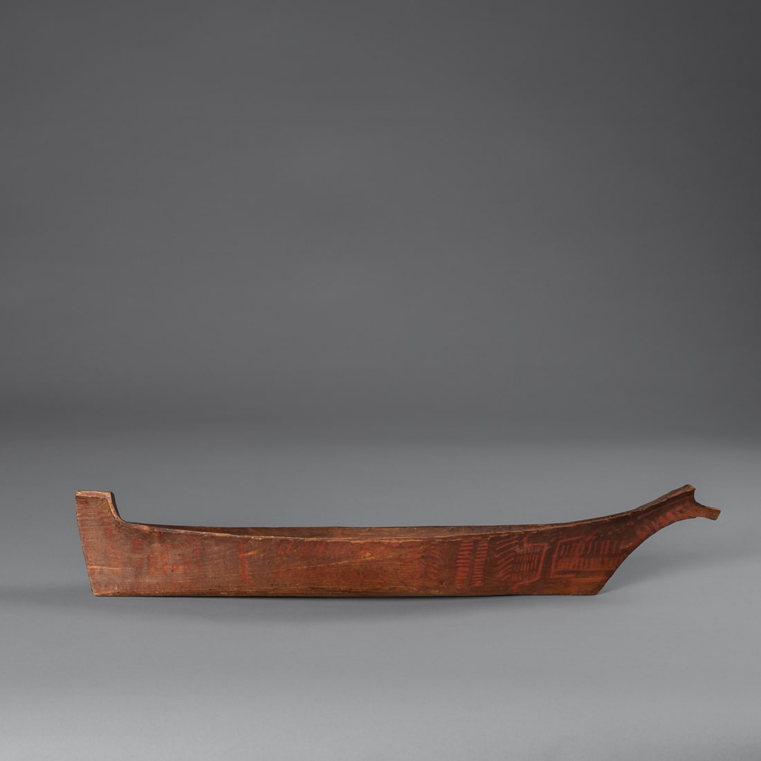 A Northwest Coast Model Canoe: Nootka (Nuu-chah-nulth)/Makah, a carved wood model canoe of Nootka (Nuu-chah-nulth) type, late 19th century, by Nootka or Makah carvers along the Pacific Northwest Coast. The hull is carved from a